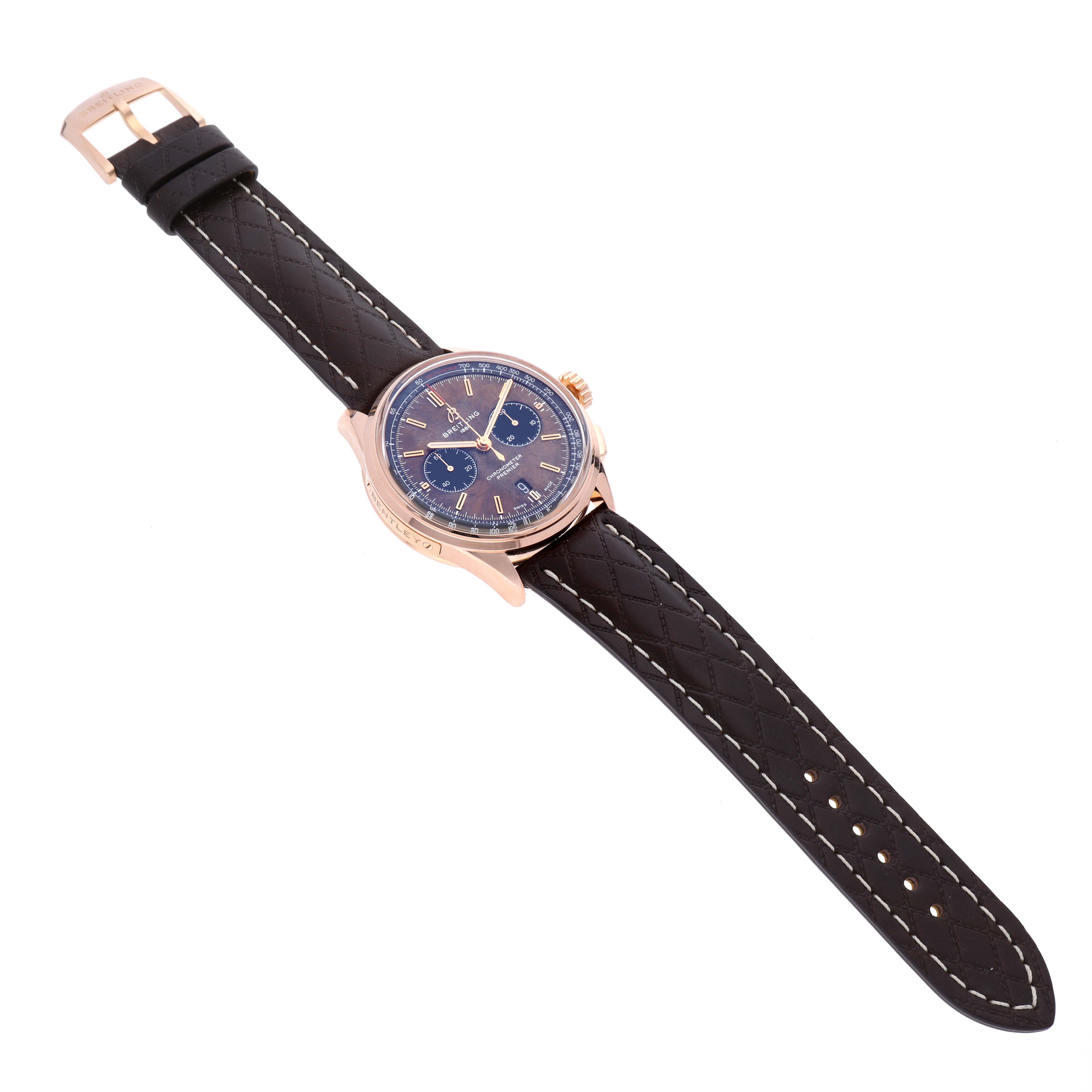 The Breitling Limited Series watch is shown at a slight angle, displaying its blue dial, rose gold case, and black leather strap.