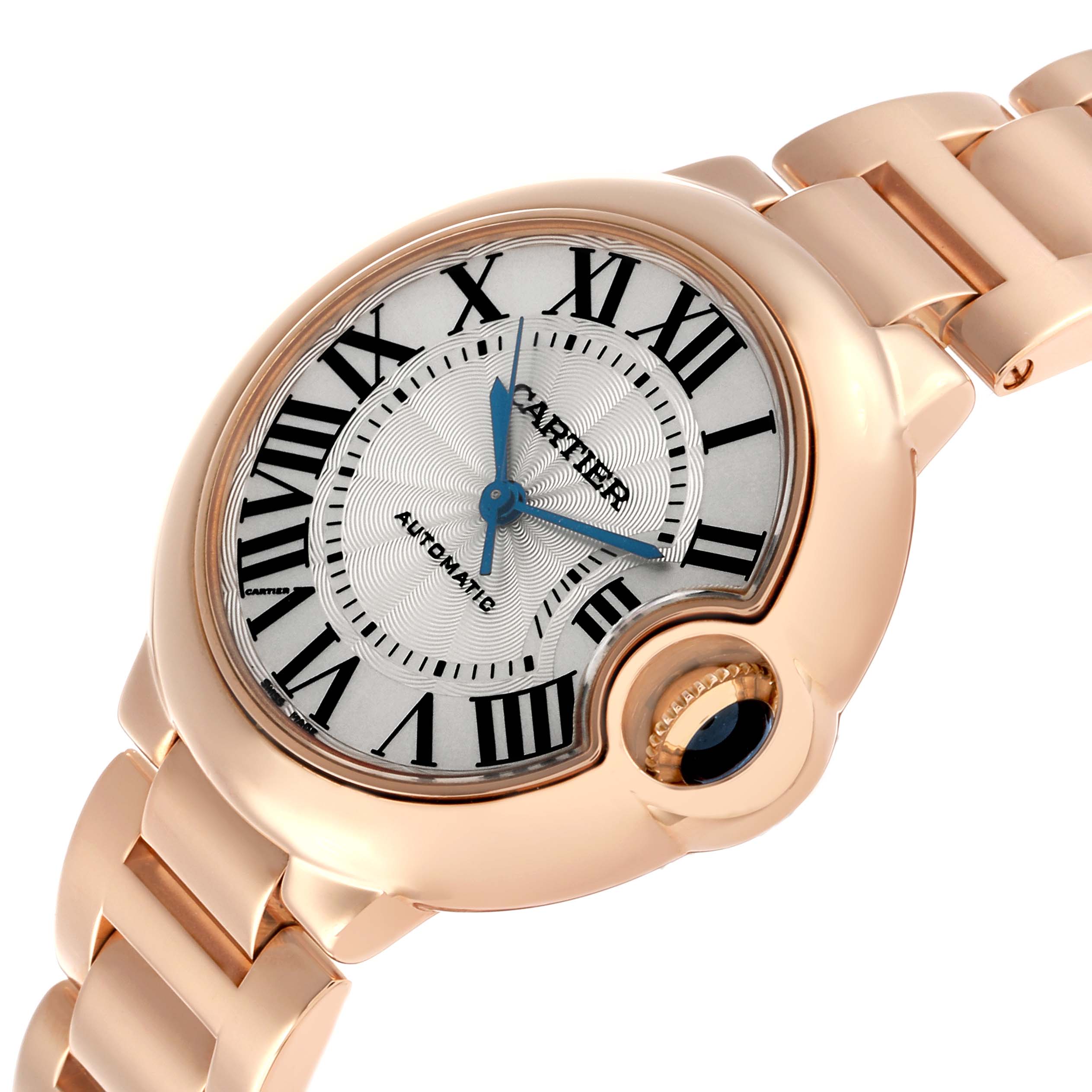 The Cartier Ballon Bleu W6920096 Women's Rose Gold Silver Dial watch is shown at an angled view, highlighting its face, Roman numerals, blue hands, and bracelet.