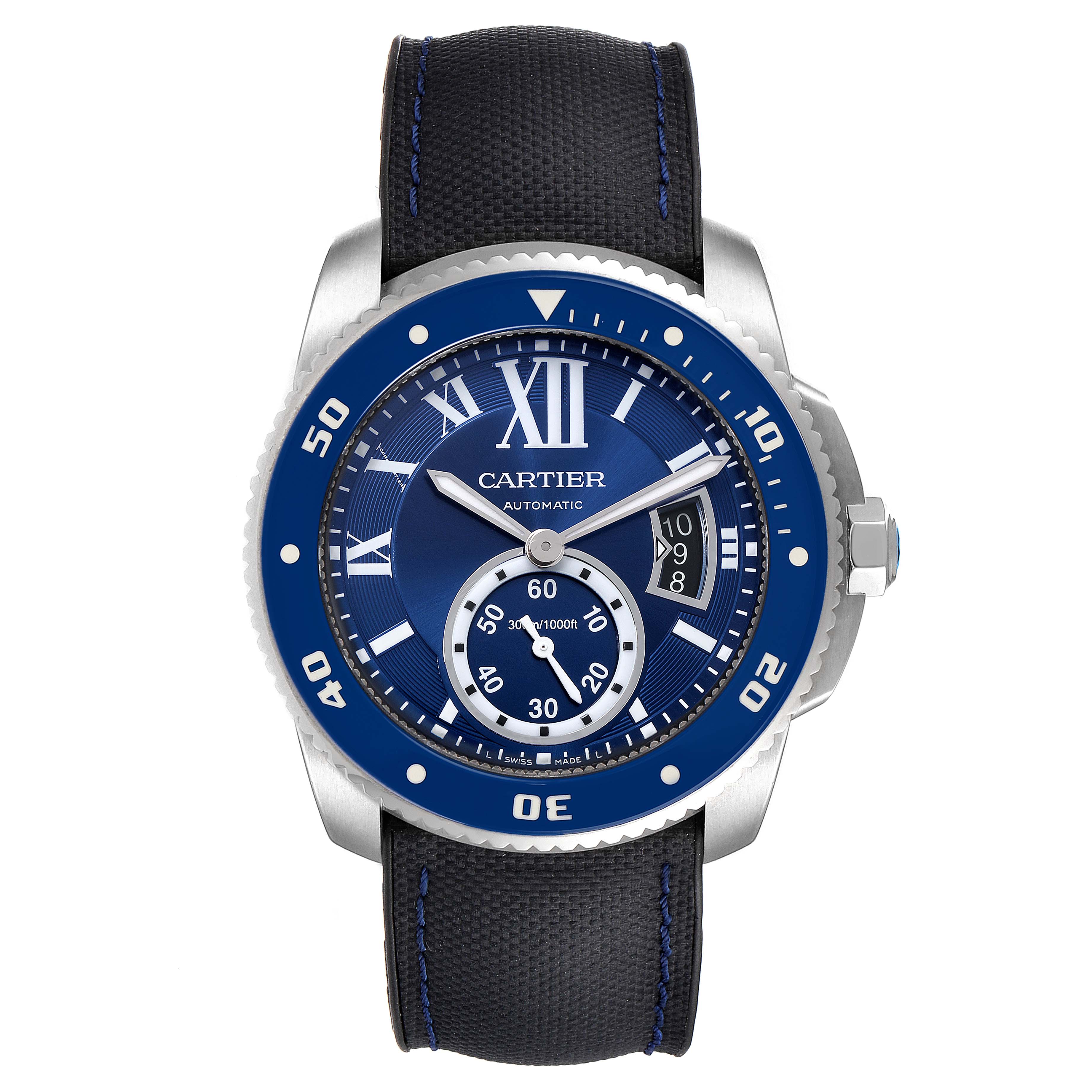 The image shows a front view of a Calibre de Cartier watch by Cartier, displaying its blue dial, bezel, and black strap.
