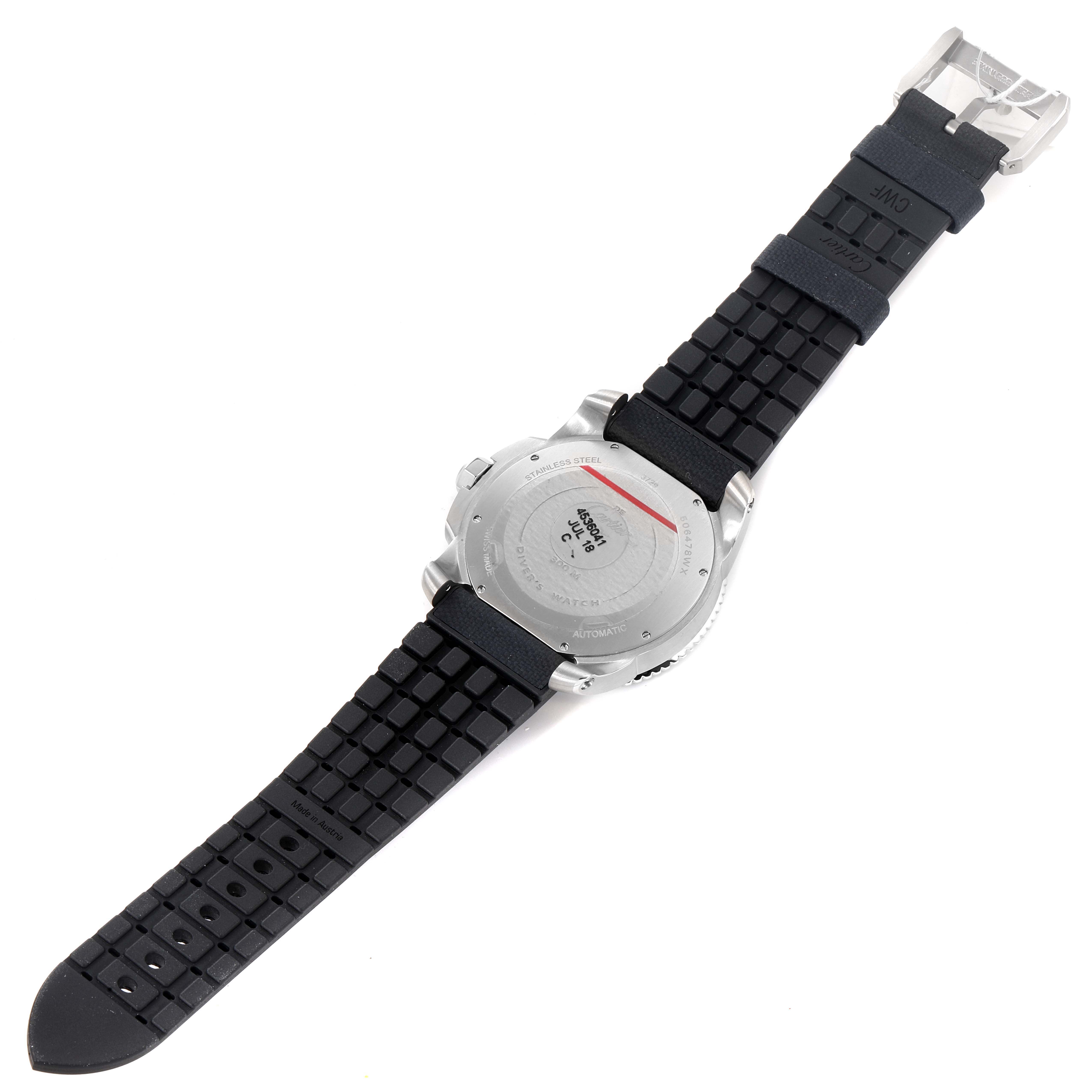 The image displays the back side of a Calibre de Cartier watch by Cartier, highlighting its case back and rubber strap.