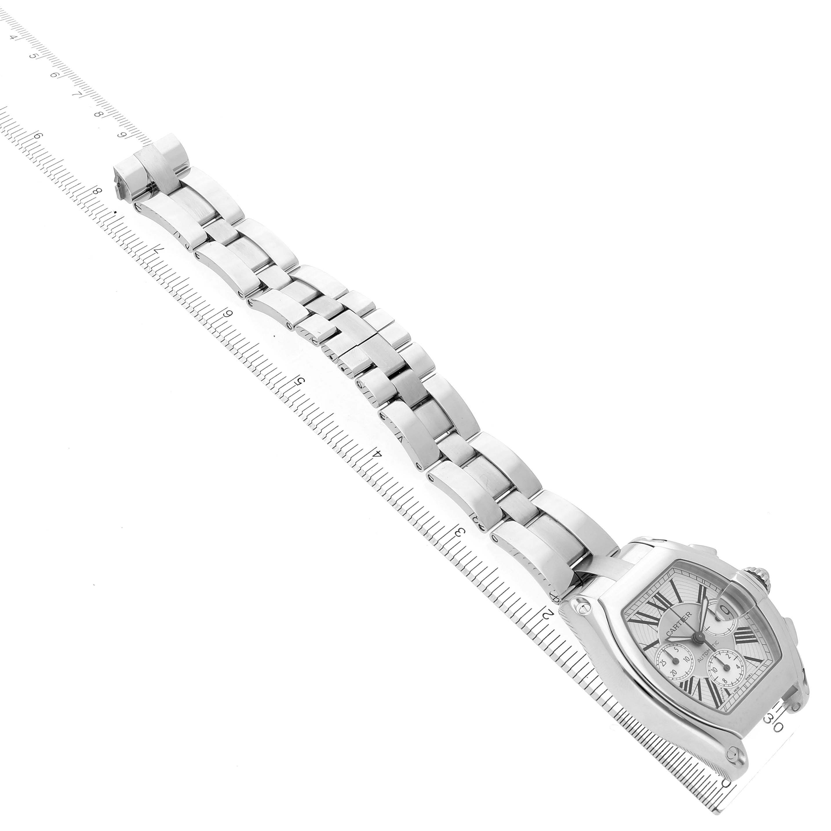 The Cartier Roadster W62019X6 Men's Stainless Steel Silver Dial W62019X6 Men's Stainless Steel Silver Dial watch is shown at an angle, displaying the full bracelet and dial, aligned with a ruler for size reference.