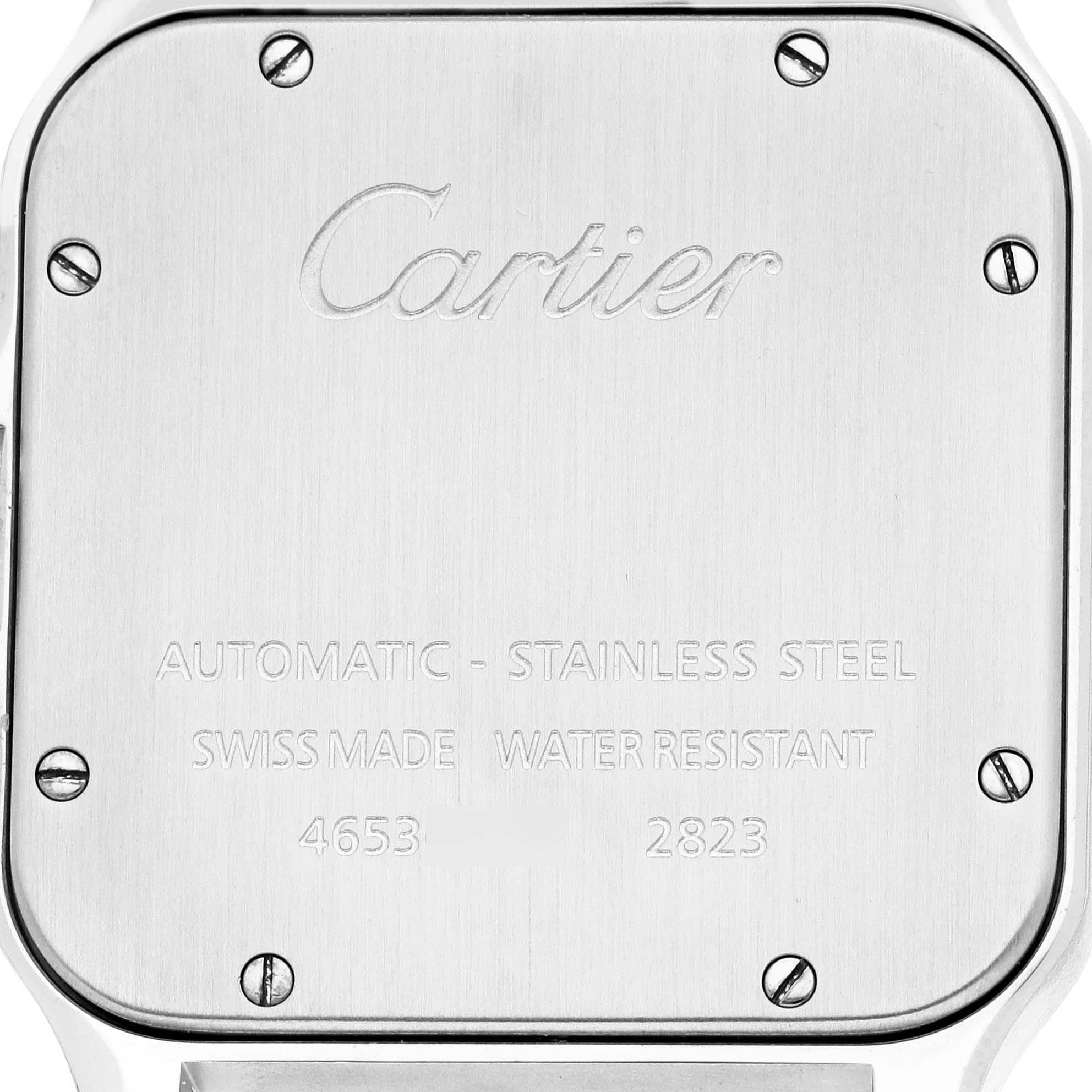 The image shows the back case of a Cartier Santos W20098D6 Men's Stainless Steel Silver Dial watch, featuring engraving and six screws at a straight angle.