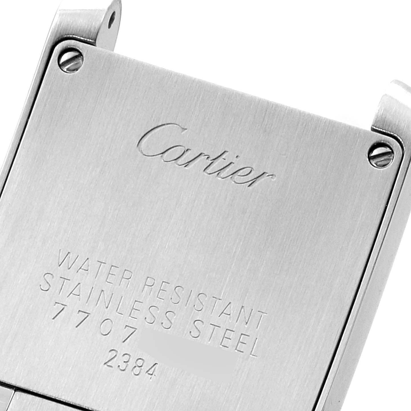This is a close-up view of the back case of the Cartier Tank Française watch, showing the engraved details and screws.