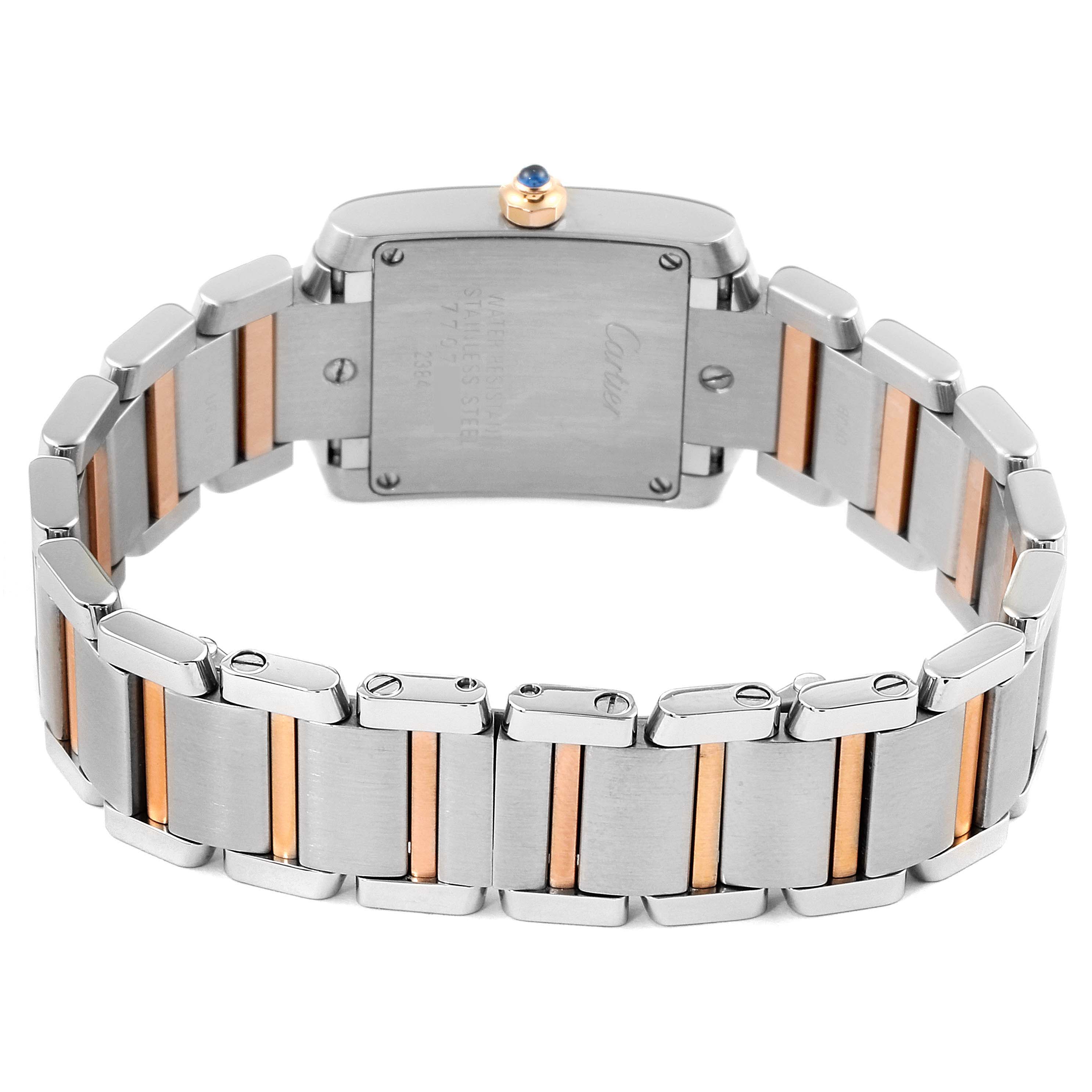 This image shows the backside of the Tank Francaise watch by Cartier, highlighting the metal bracelet with gold accents and the case back.