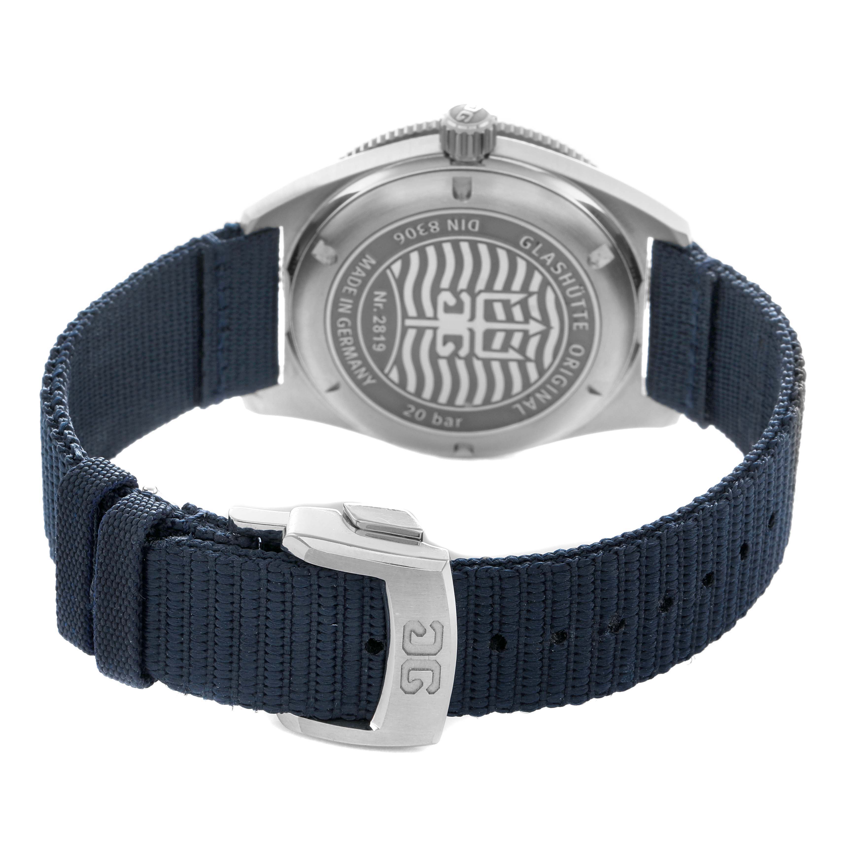 The Glashutte Original 1-39-11-09-81-34 Men's Stainless Steel Blue Dial watch is shown from the back, highlighting its case back and blue fabric strap with a branded clasp.