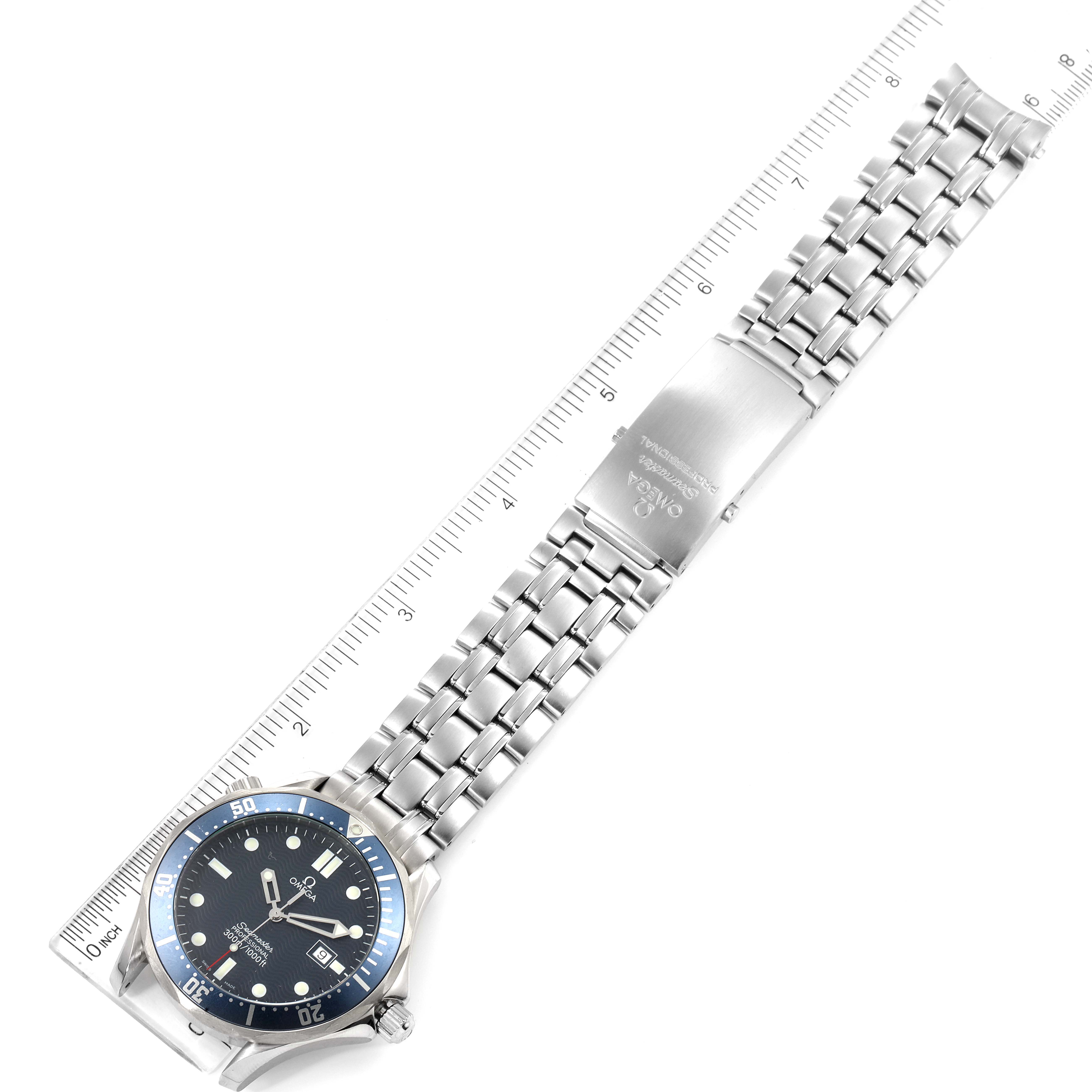 The image shows an Omega Seamaster 2541.80.00 Men's Stainless Steel Blue Dial 2541.80.00 Men's Stainless Steel Blue Dial watch laid flat with its stainless steel bracelet and clasp visible, measured against a ruler.