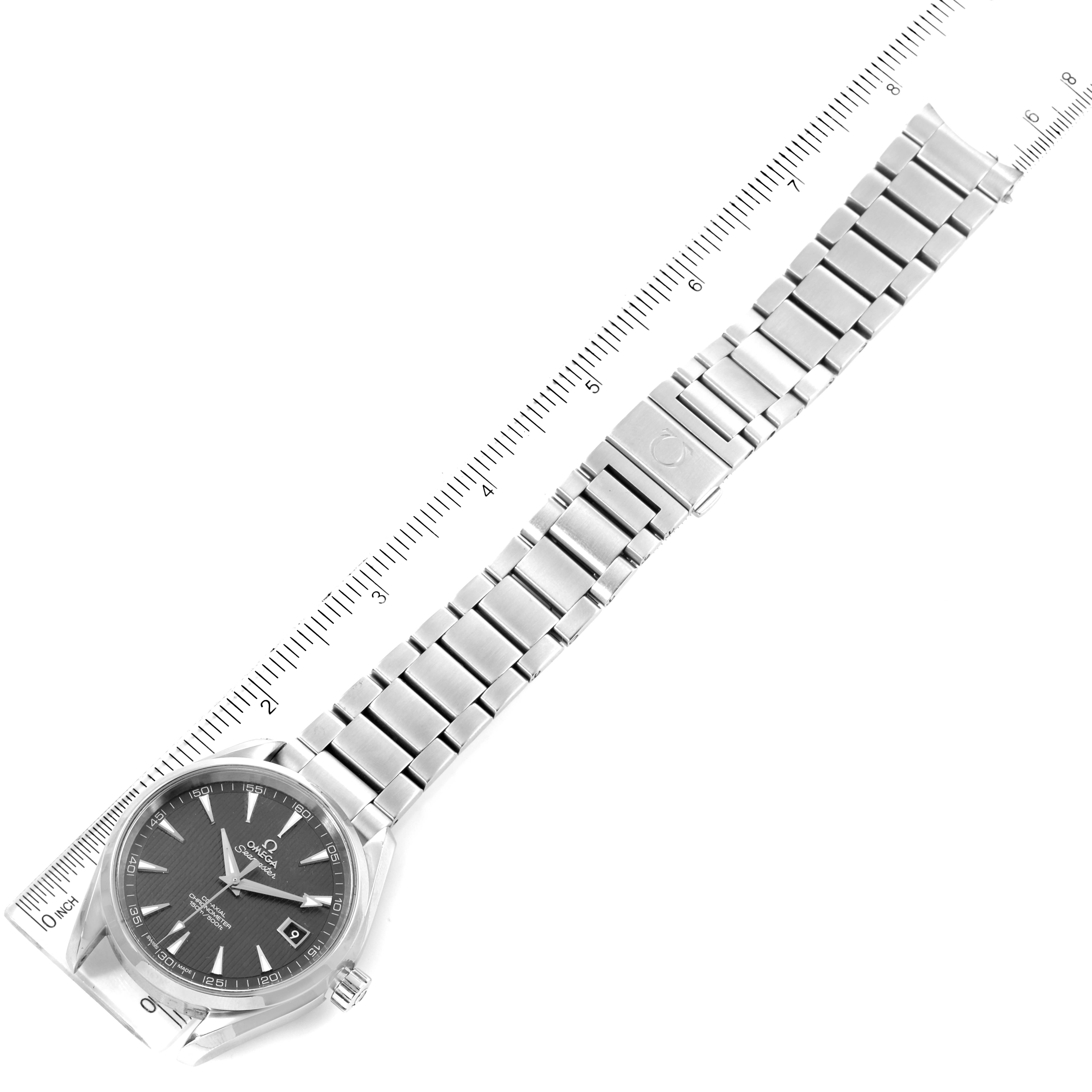 The Omega Aqua Terra 231.10.42.21.06.001 Men's Stainless Steel Grey Dial 231.10.42.21.06.001 Men's Stainless Steel Grey Dial watch is shown laid flat, displaying the face, bracelet, and clasp with a ruler for scale.