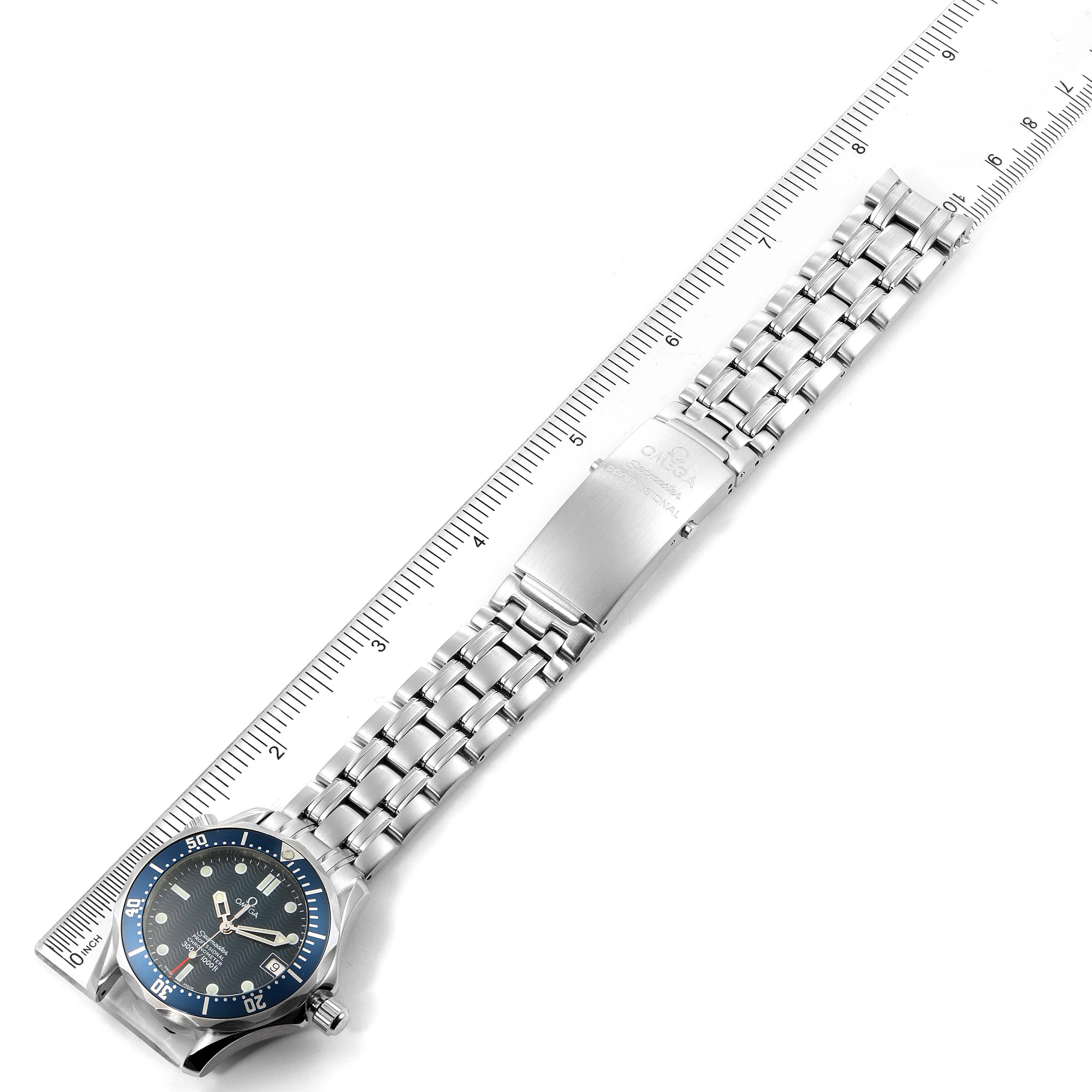 The image shows an Omega Seamaster 2551.80.00 Men
s Stainless Steel Blue Dial 2551.80.00 Men
s Stainless Steel Blue Dial watch positioned flat with a ruler measuring its length.