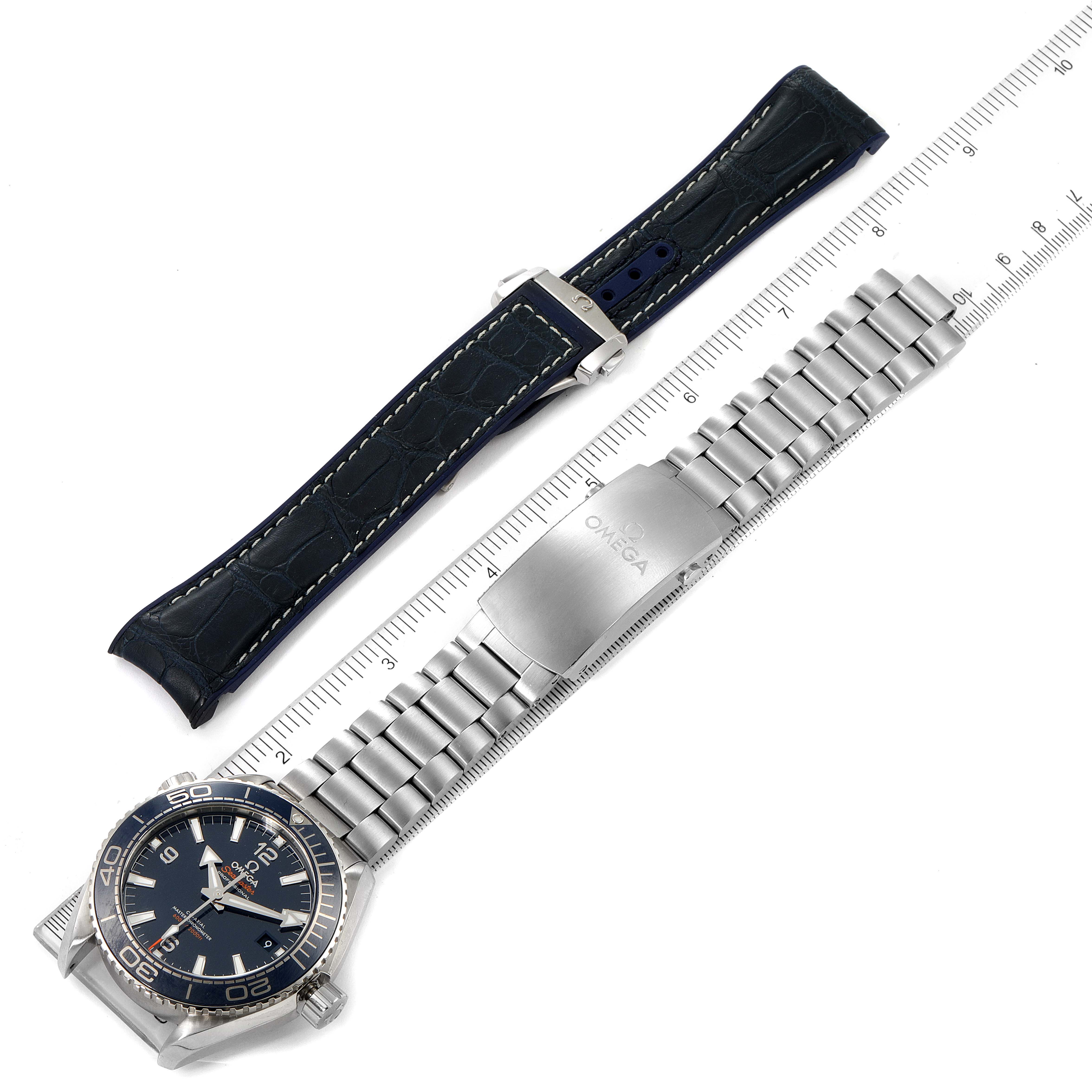 This image shows an Omega Planet Ocean 215.30.44.21.03.001 Men's Stainless Steel Blue Dial 215.30.44.21.03.001 Men's Stainless Steel Blue Dial watch with a metal bracelet and an additional leather strap, viewed from above.