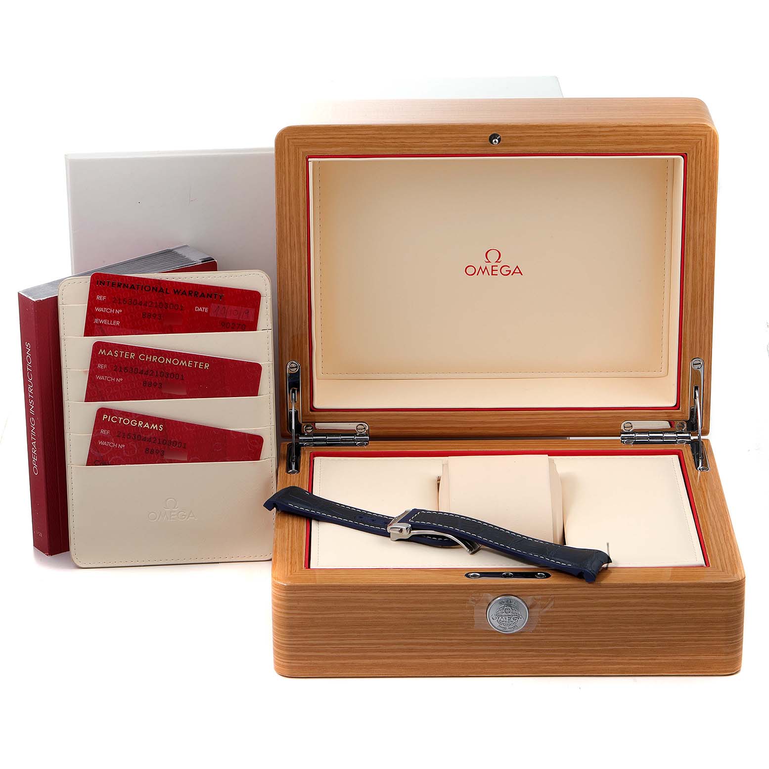 The image shows an Omega Planet Ocean 215.30.44.21.03.001 Men's Stainless Steel Blue Dial 215.30.44.21.03.001 Men's Stainless Steel Blue Dial watch box with certification cards and an extra strap, viewed from the front.