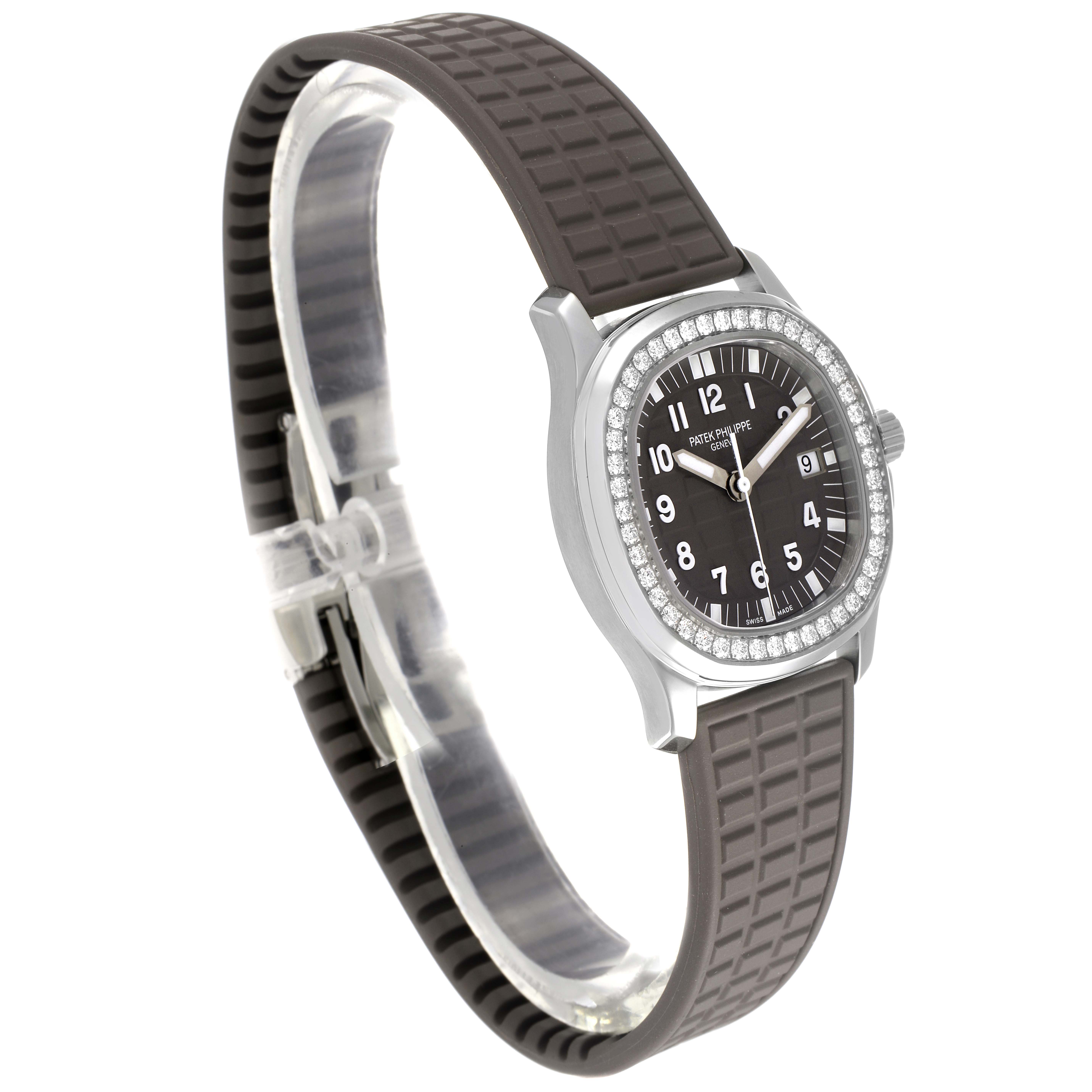 The image shows a side angle of the Patek Philippe Aquanaut 5067A-023 Women's Stainless Steel Brown Dial 5067A-023 Women's Stainless Steel Brown Dial watch, highlighting its black dial, rubber strap, and diamond bezel.