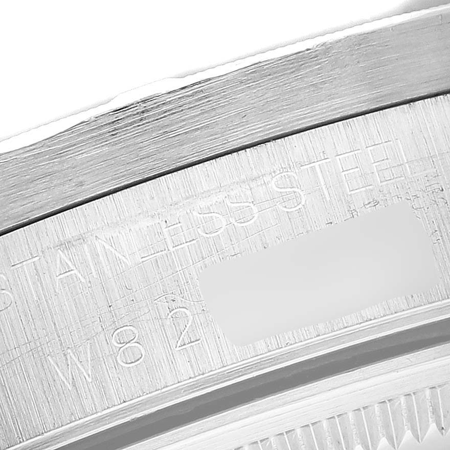 The image shows a close-up view of the engraved edge, specifically the "STAINLESS STEEL" text, of a Rolex Air-King 14010 Men's Stainless Steel Black Dial 14010 Men's Stainless Steel Black Dial watch.