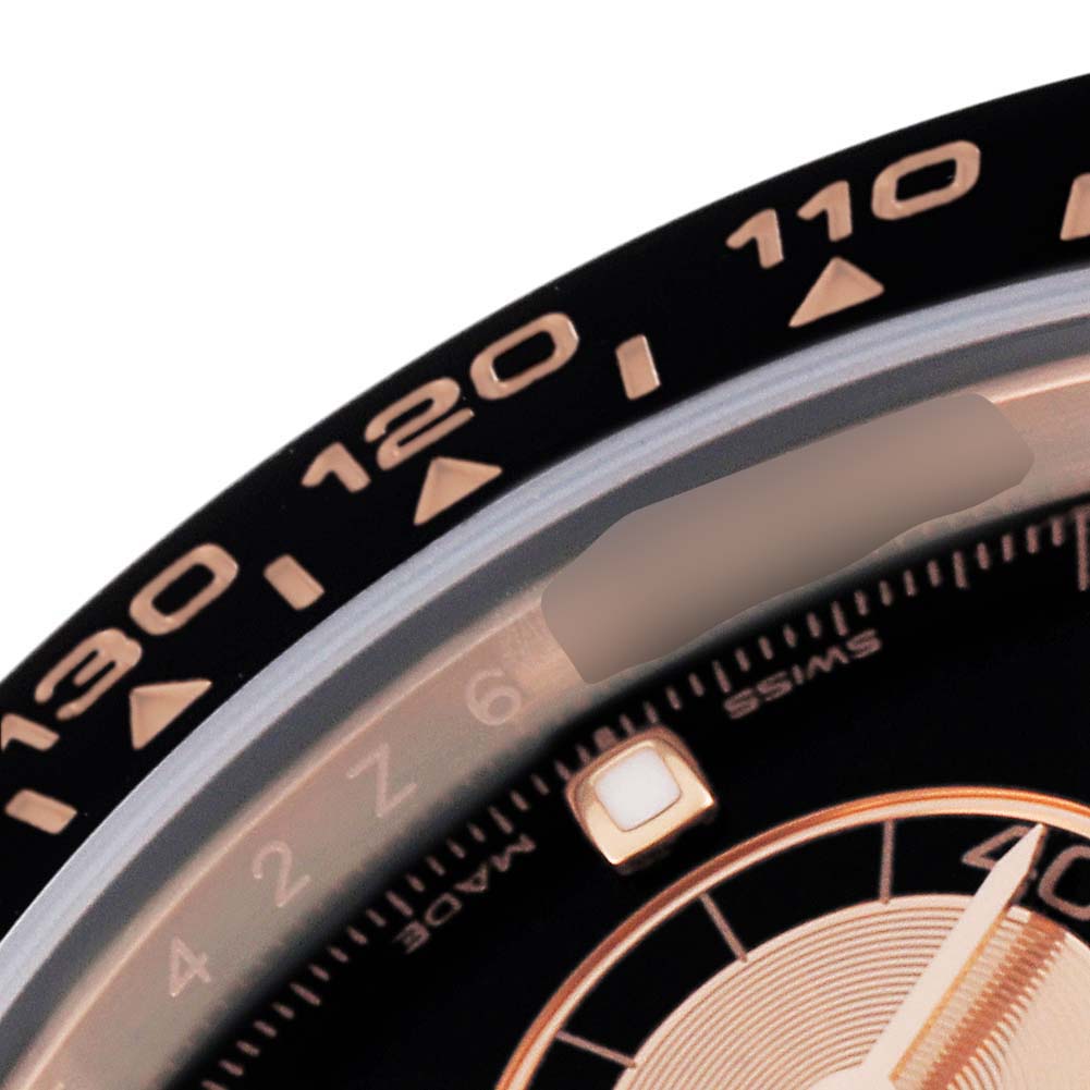 This image shows a close-up of the bezel and part of the dial of a Rolex Daytona 116515LN Men's Rose Gold Black Dial 116515LN Men's Rose Gold Black Dial watch.