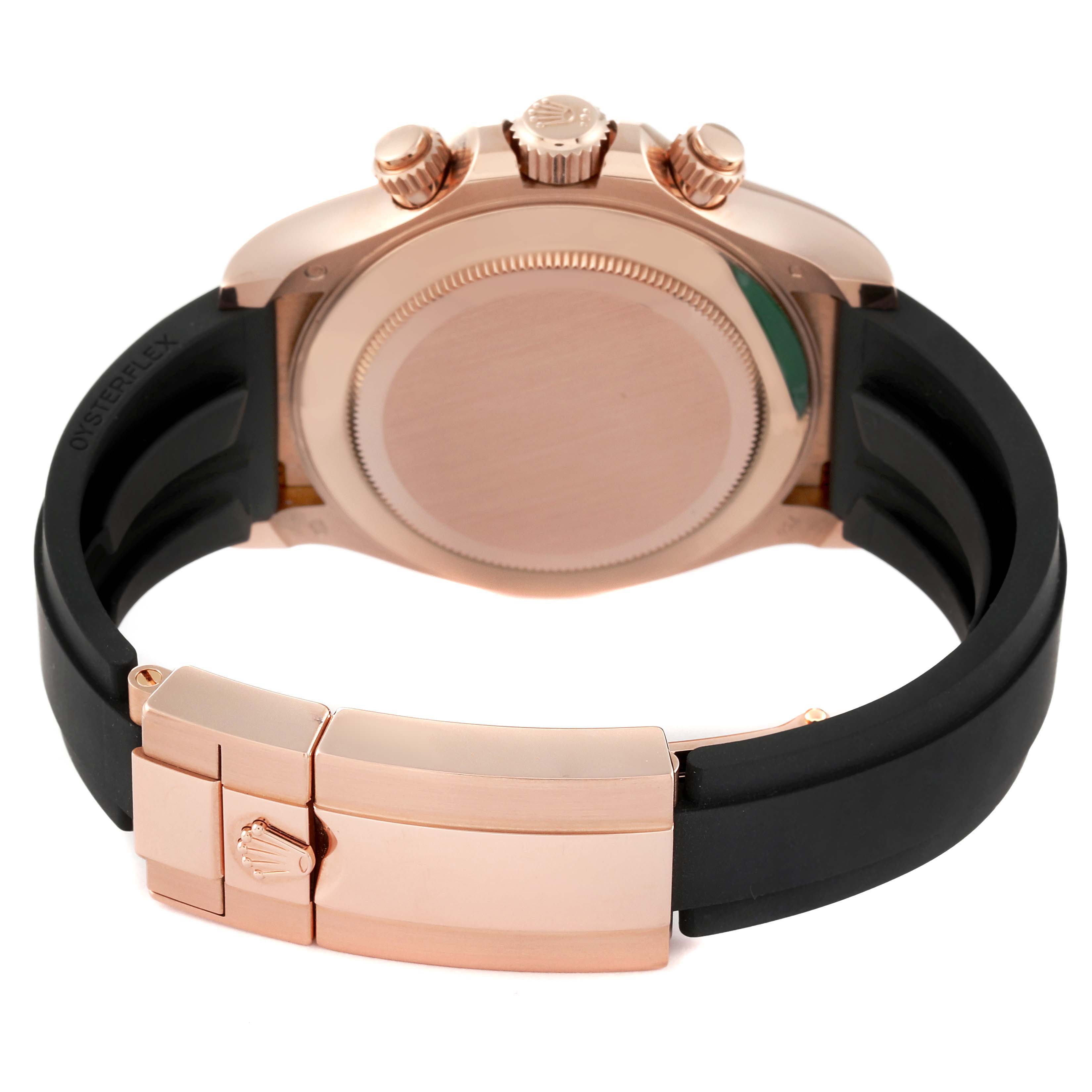 The image shows the back of a Rolex Daytona 116515LN Men's Rose Gold Black Dial 116515LN Men's Rose Gold Black Dial watch with a visible clasp and black rubber strap.