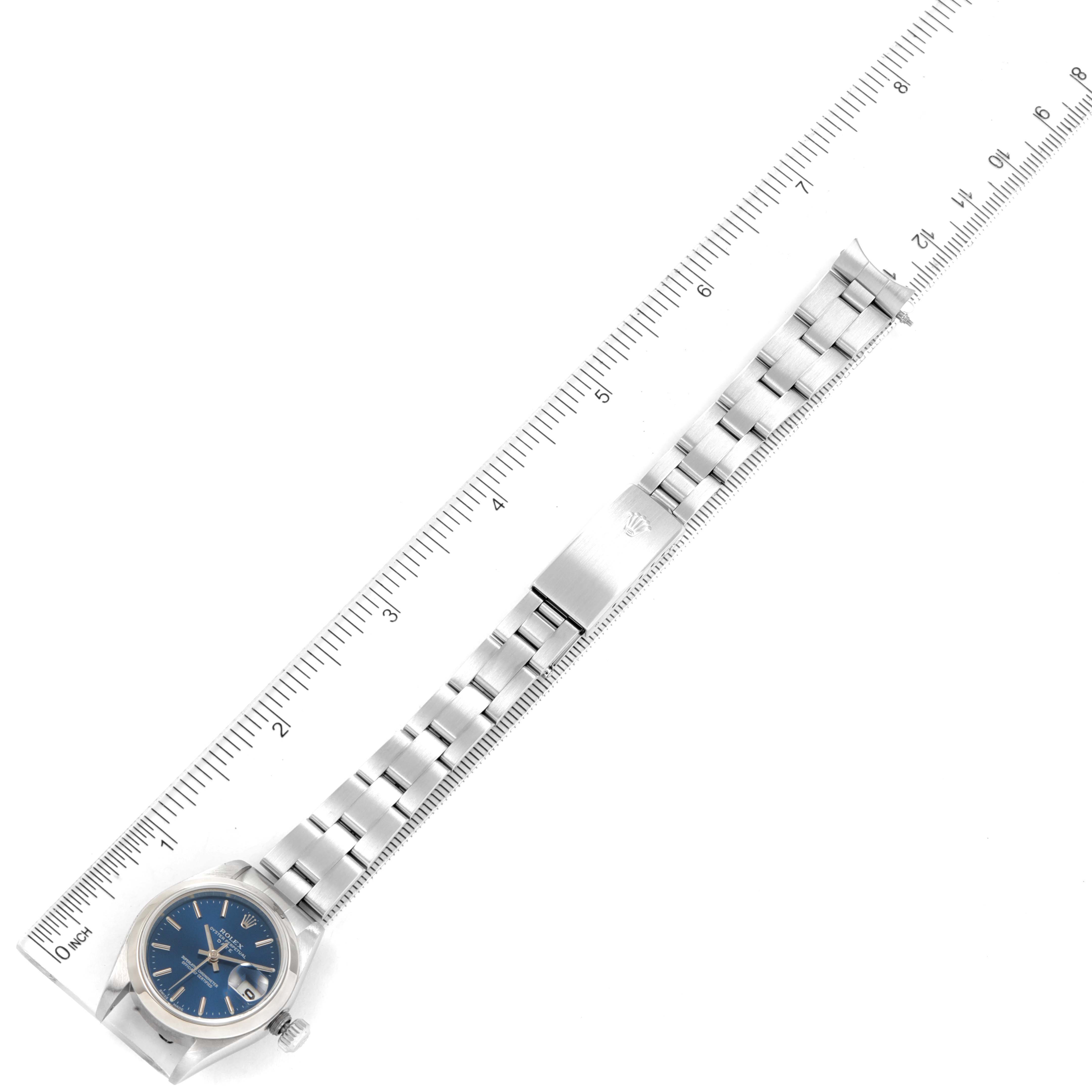 The image shows a Rolex Date 79160 Women's Stainless Steel Blue Dial 79160 Women's Stainless Steel Blue Dial model watch laid flat alongside a ruler, highlighting the full length of the watch including the face and bracelet.