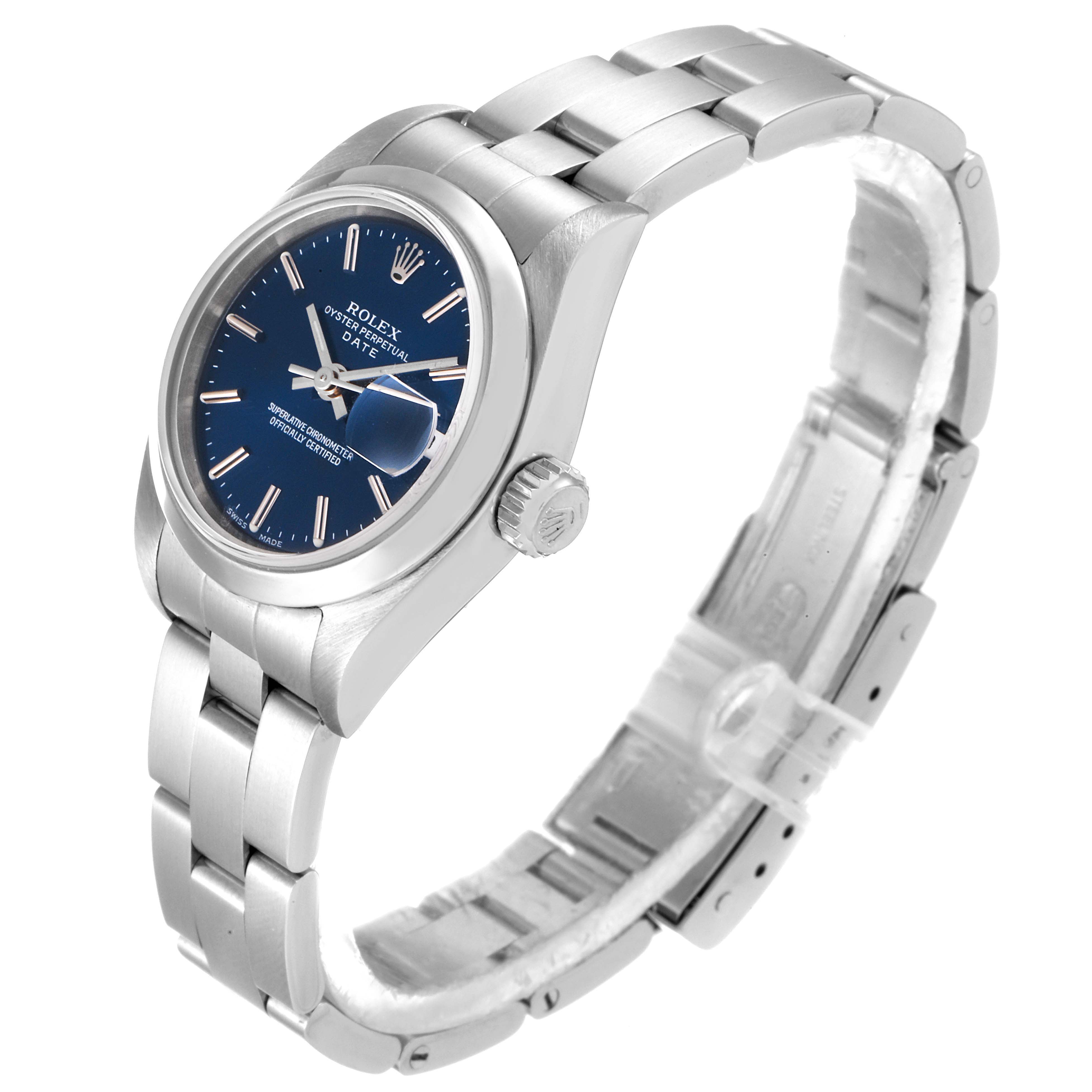 The image shows a side and partial top view of a Rolex Date 79160 Women's Stainless Steel Blue Dial 79160 Women's Stainless Steel Blue Dial model watch, highlighting its blue dial, crown, and metal bracelet.