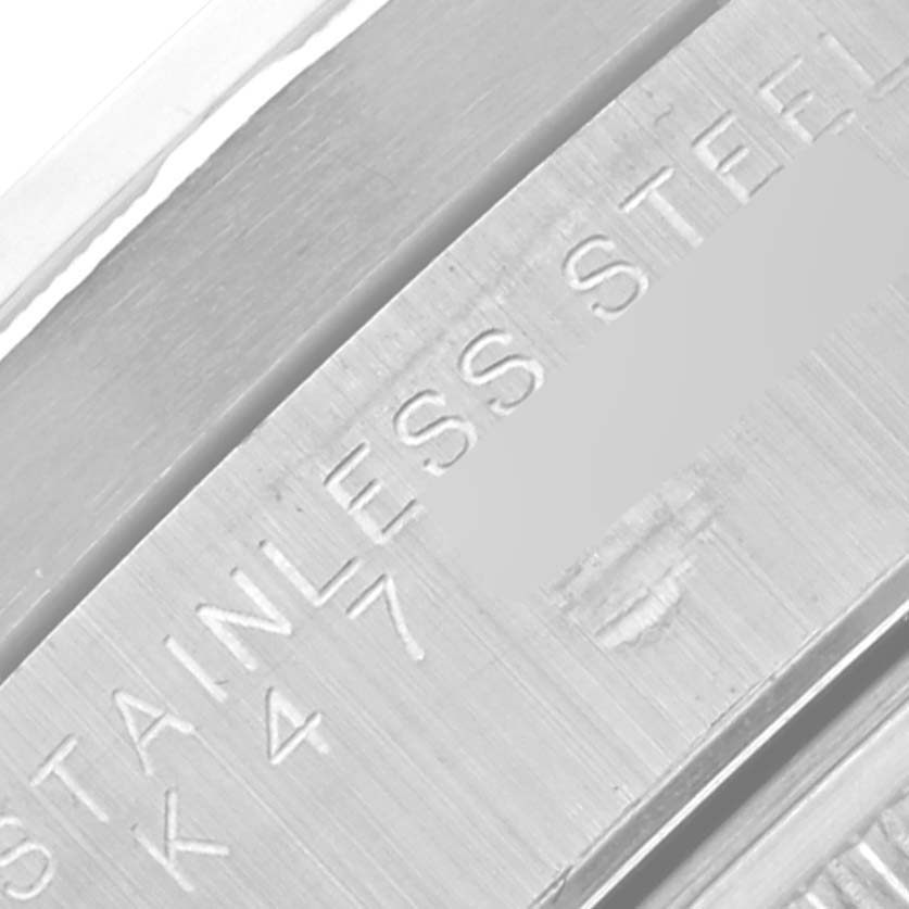 The image shows a close-up of the metal engraving on the Rolex Date 15210 Men's Stainless Steel Silver Dial 15210 Men's Stainless Steel Silver Dial model, highlighting the "STAINLESS STEEL" text.