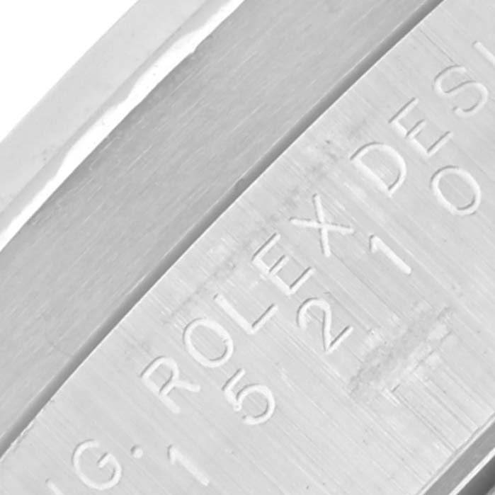 The image shows a close-up of the engraved edge of a Rolex Date 15210 Men's Stainless Steel Silver Dial 15210 Men's Stainless Steel Silver Dial watch.