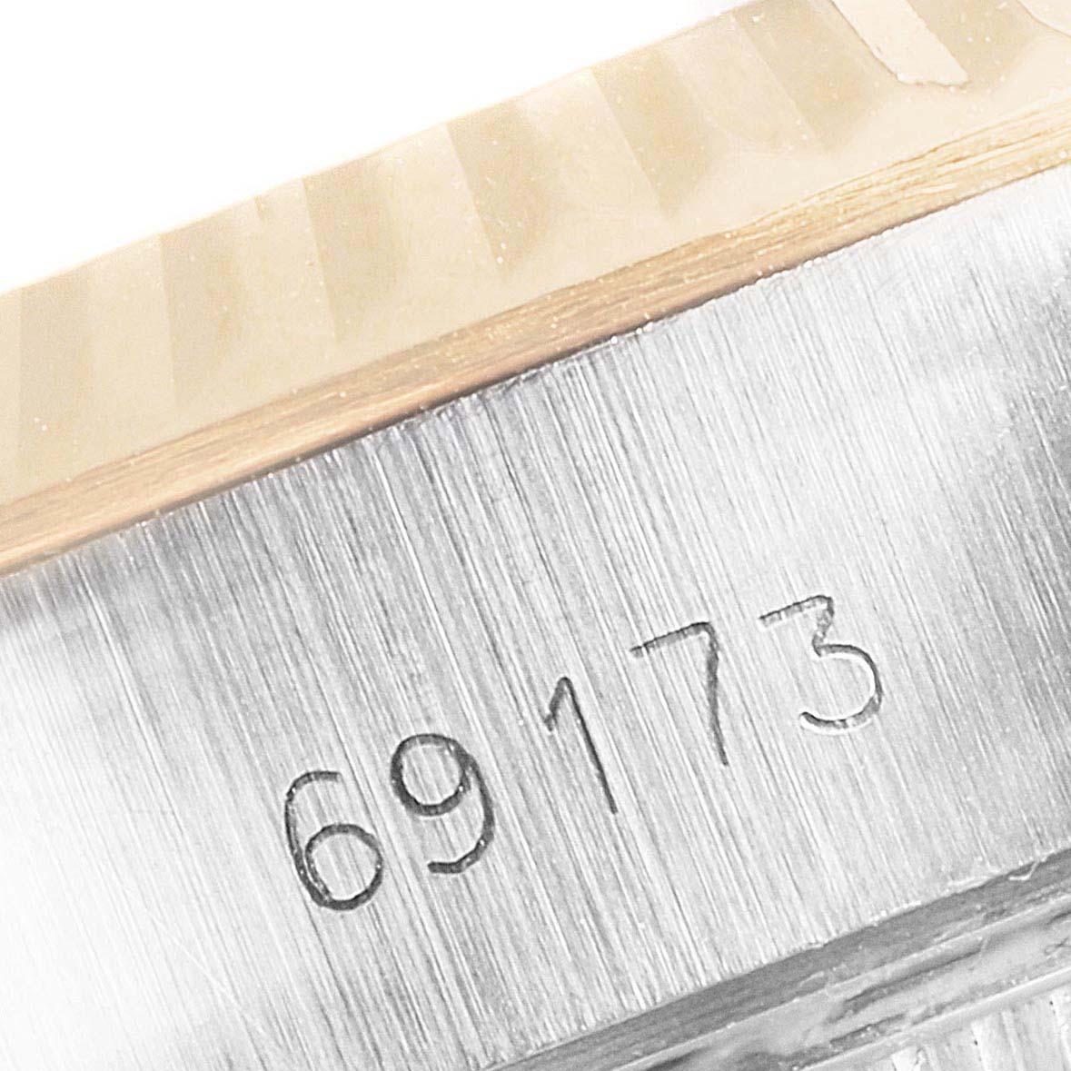This image shows a close-up angle of the serial number "69173" engraved on the case of the Rolex Datejust 69173 Women
s Steel and Gold (two tone) Champagne Dial 69173 Women
s Steel and Gold (two tone) Champagne Dial watch.