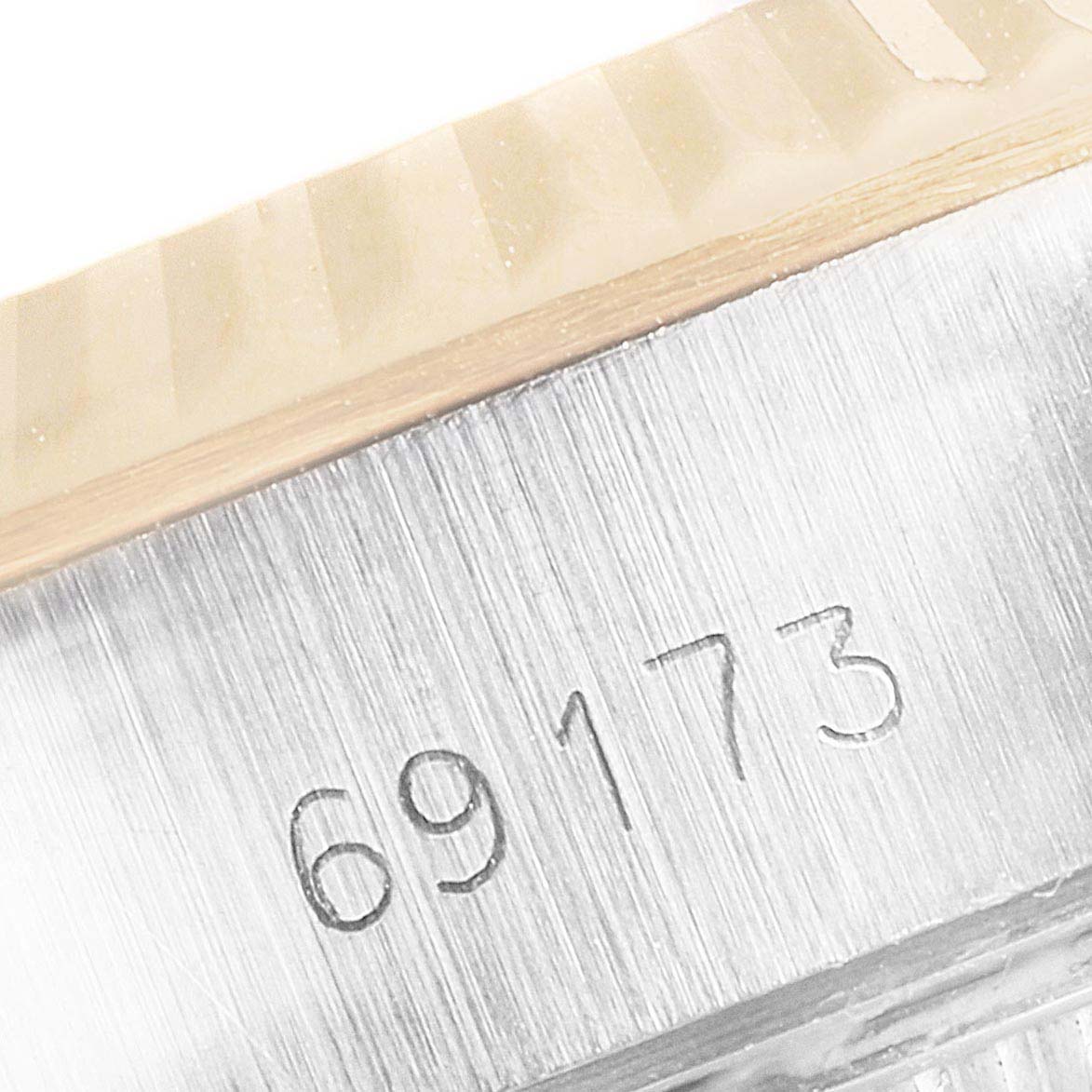 This is a close-up of the case and serial number (69173) from a Rolex Datejust 69173 Women
s Steel and Gold (two tone) Champagne Dial 69173 Women
s Steel and Gold (two tone) Champagne Dial model watch.