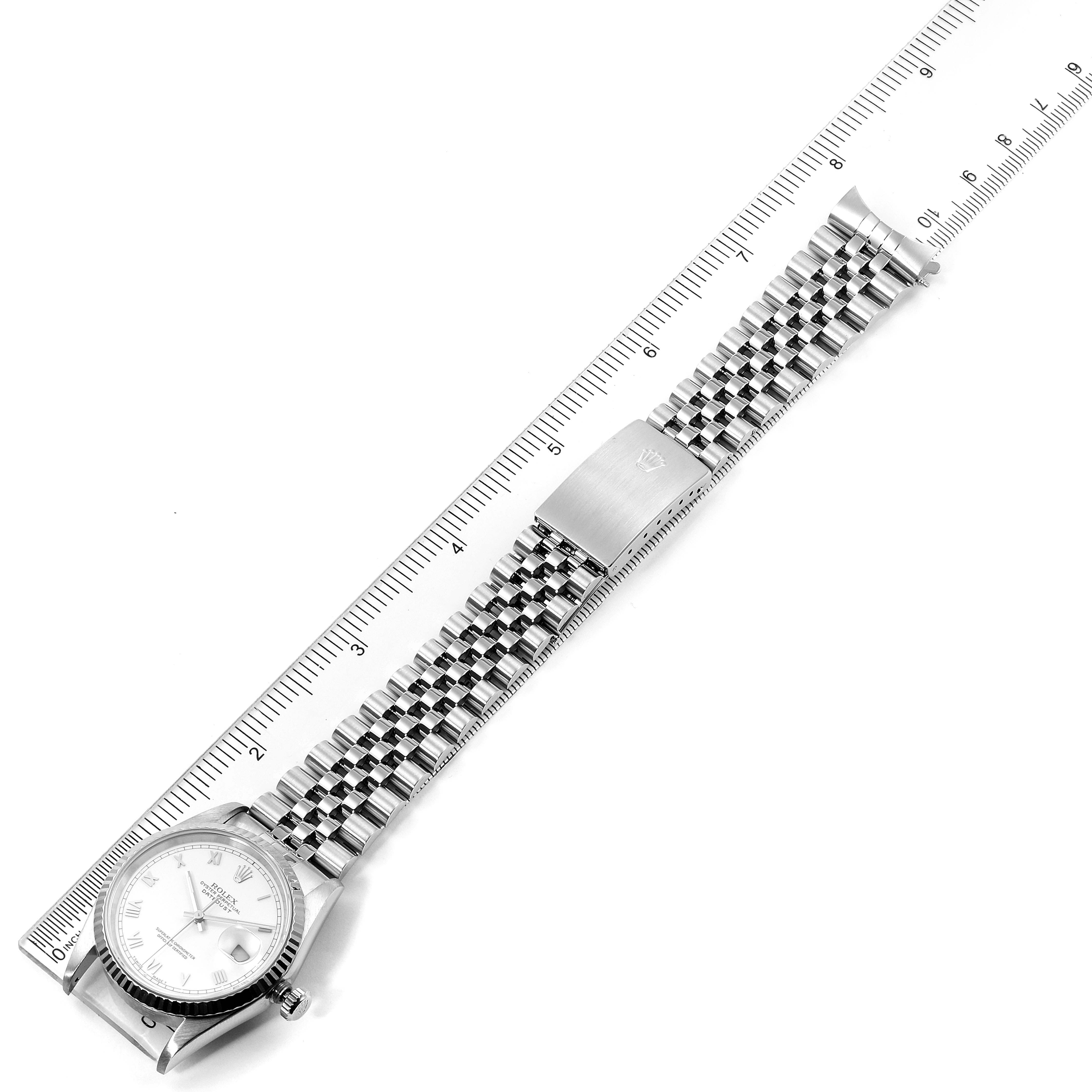 The image shows the Rolex Datejust 16234 Men's Stainless Steel White Dial 16234 Men's Stainless Steel White Dial watch placed alongside a ruler, featuring its face, case, and bracelet fully extended.