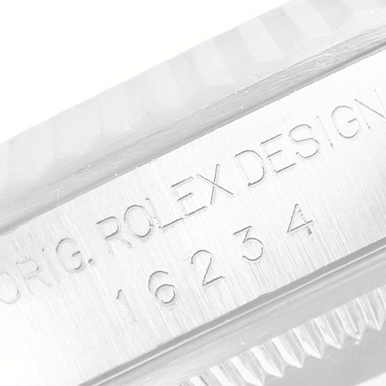 The image shows a close-up of the side engravings on the bezel of a Rolex Datejust 16234 Men's Stainless Steel White Dial 16234 Men's Stainless Steel White Dial watch.