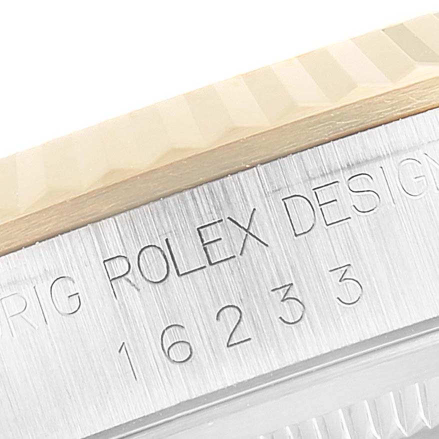 The image shows a close-up of the bezel and the engraved side of the Rolex Datejust 16233 Men's Steel and Gold (two tone) Champagne Dial 16233 Men's Steel and Gold (two tone) Champagne Dial watch model 16233.