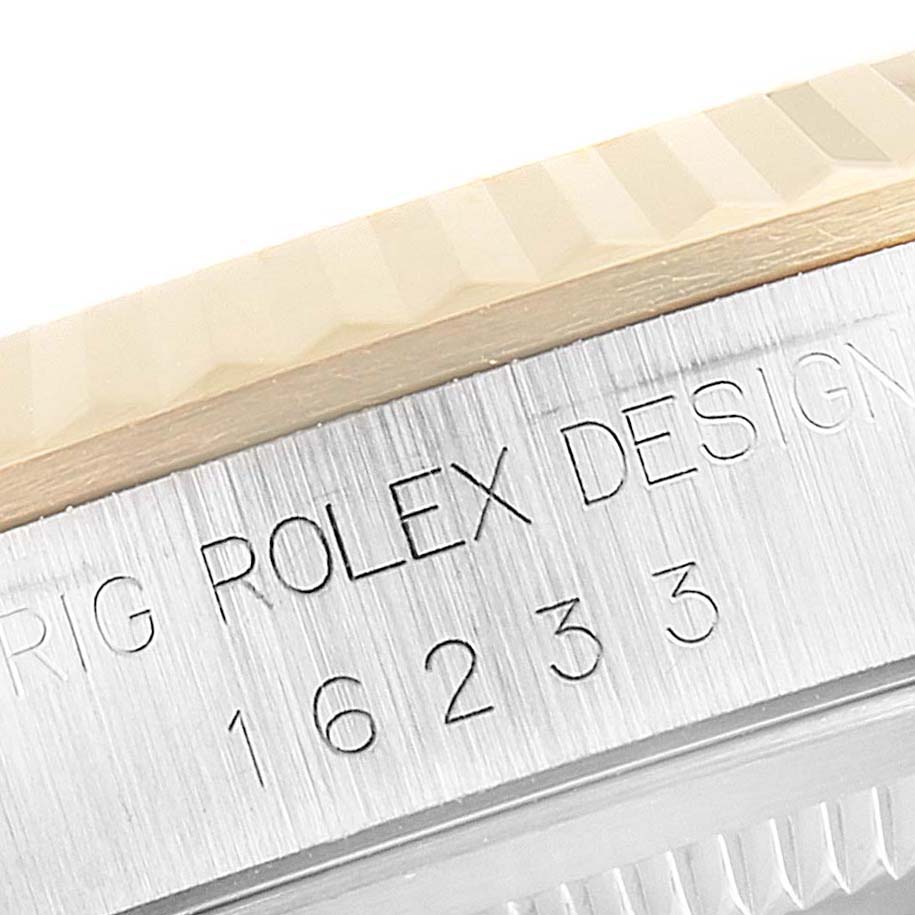 This close-up angle shows the engraved case side of a Rolex Datejust 16233 Men's Steel and Gold (two tone) Champagne Dial 16233 Men's Steel and Gold (two tone) Champagne Dial model, including the reference number.