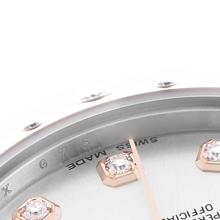 The image shows a close-up of a Rolex Mid-Size 178341 Women's Steel and Gold (two tone) Silver Dial watch focusing on the bezel, part of the dial, and diamond hour markers.
