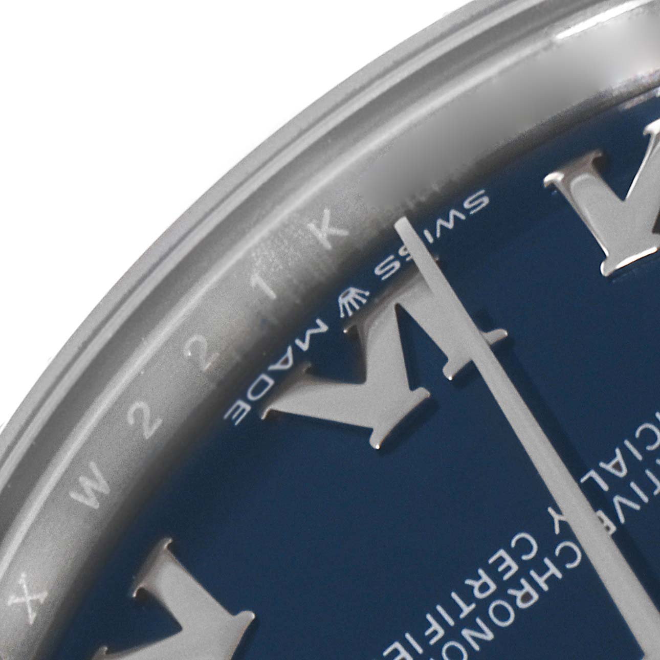 This image shows a close-up of the Rolex Mid-Size 278274 Women
s Stainless Steel Blue Dial 278274 Women
s Stainless Steel Blue Dial model, focusing on part of the dial and bezel at an oblique angle.
