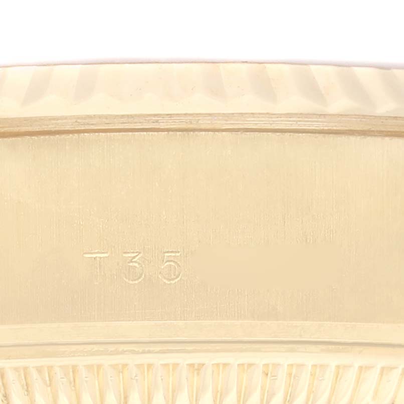 The image shows a close-up of the engraved bezel on a Rolex President 69178G Women
s Yellow Gold Champagne Dial 69178G Women
s Yellow Gold Champagne Dial model watch.