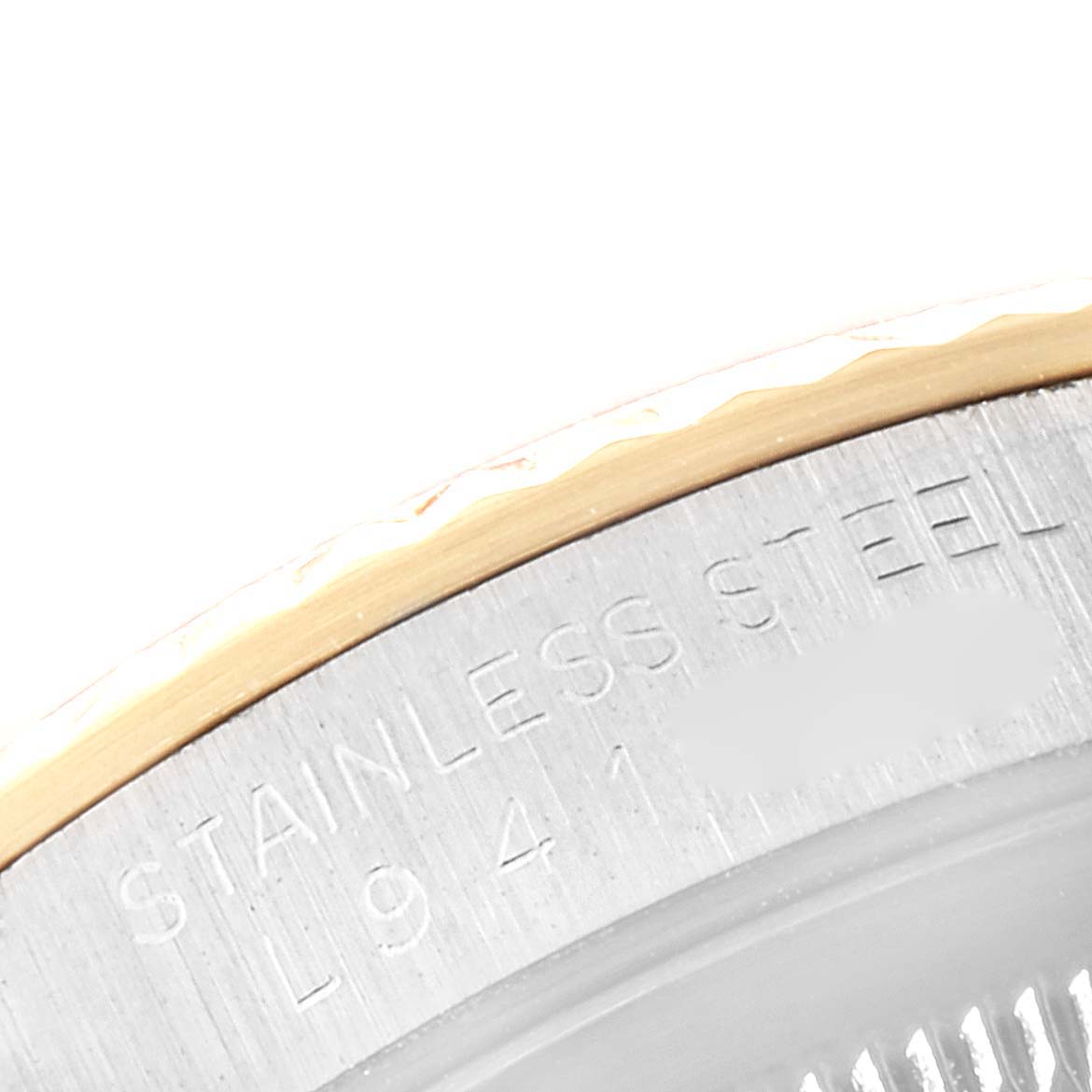 This image shows a close-up of the fluted bezel and the stainless steel casing of a Rolex Datejust 16233 Men's Steel and Gold (two tone) Champagne Dial 16233 Men's Steel and Gold (two tone) Champagne Dial watch.