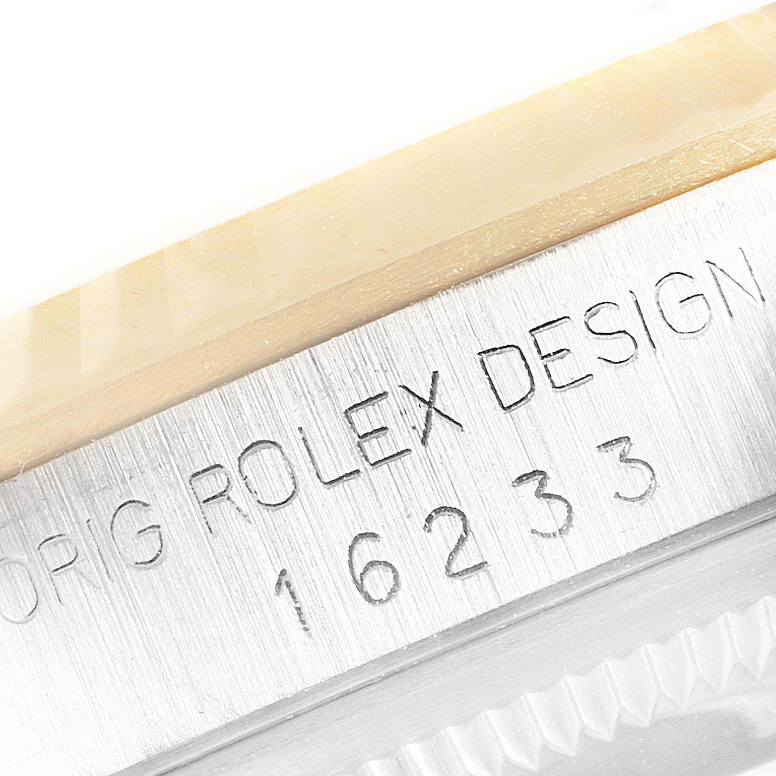 This is a close-up of the Rolex Datejust 16233 Men's Steel and Gold (two tone) Champagne Dial 16233 Men's Steel and Gold (two tone) Champagne Dial model 16233, showing the engraved serial number on the watch case.