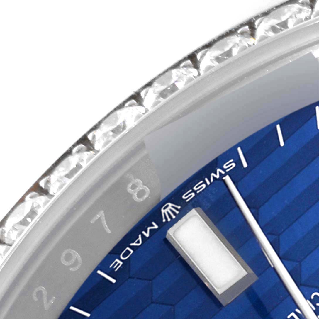 This close-up of the Rolex Datejust 126284RBR Men's Stainless Steel Blue Dial 126284RBR Men's Stainless Steel Blue Dial watch shows a portion of the blue dial, bezel with diamonds, and part of the minute markers.