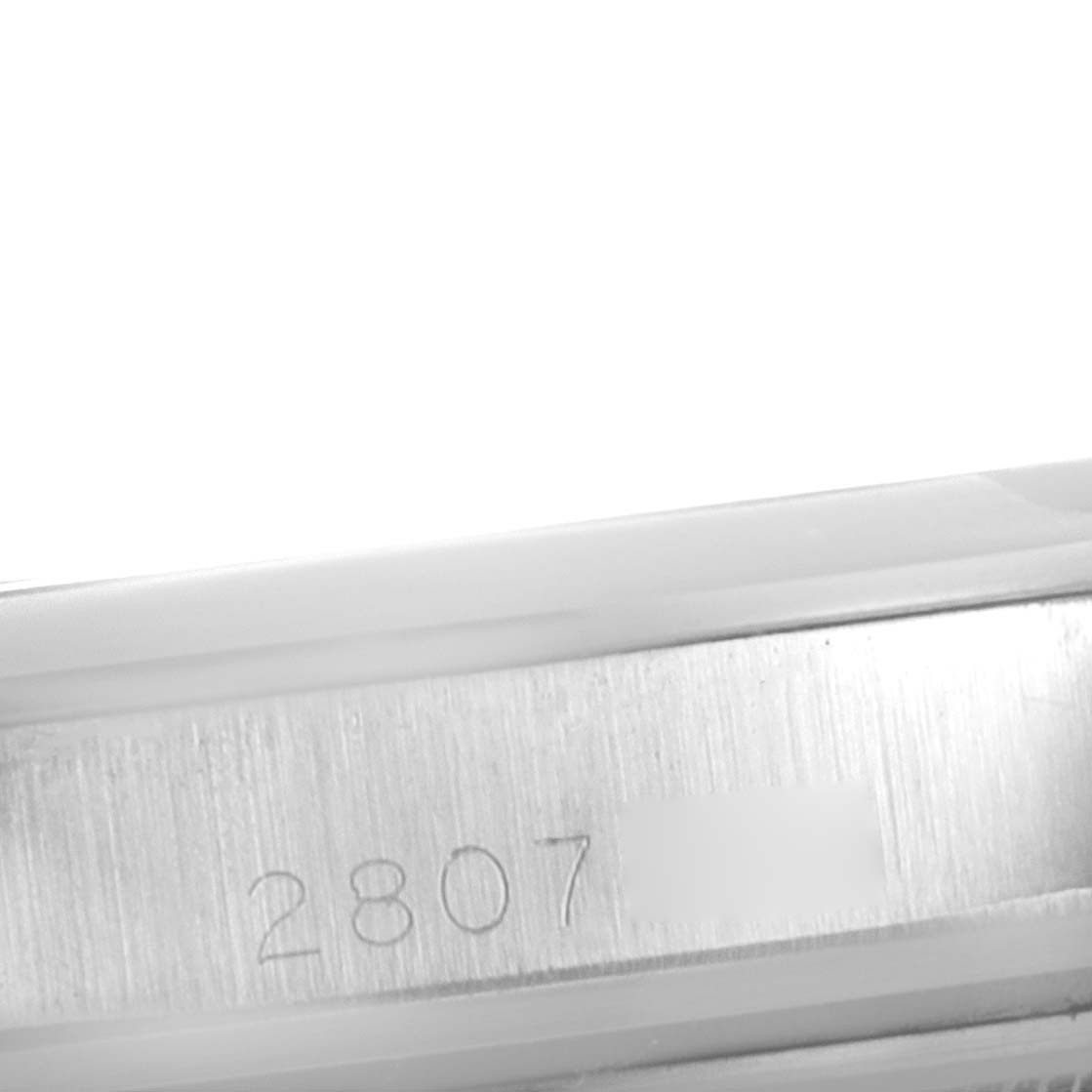 This image shows a close-up of the engraved serial number on the side of a Rolex Vintage Collection 1600 Men's Stainless Steel Grey Dial 1600 Men's Stainless Steel Grey Dial watch case.