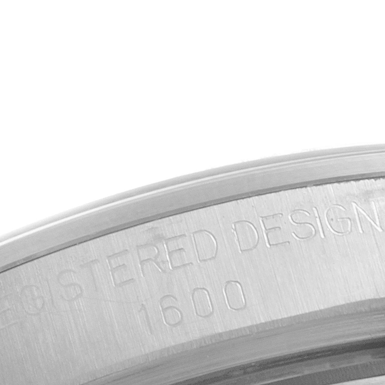 The image shows a close-up of the case side, featuring the engraved watch model number ("1600") of the Vintage Collection by Rolex.