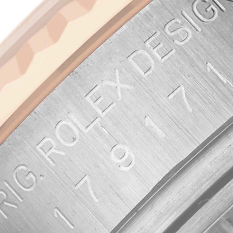 The image shows an angled close-up of the engraved side of the Rolex Datejust 179171 Women's Steel and Gold (two tone) Silver Dial 179171 Women's Steel and Gold (two tone) Silver Dial watch case.