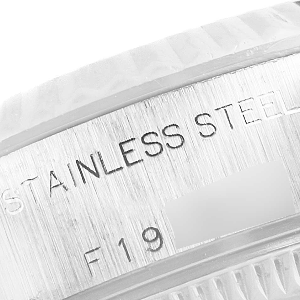 This close-up image shows the engraved stainless steel surface of the Rolex Datejust 79174 Women
s Stainless Steel White Dial 79174 Women
s Stainless Steel White Dial model.
