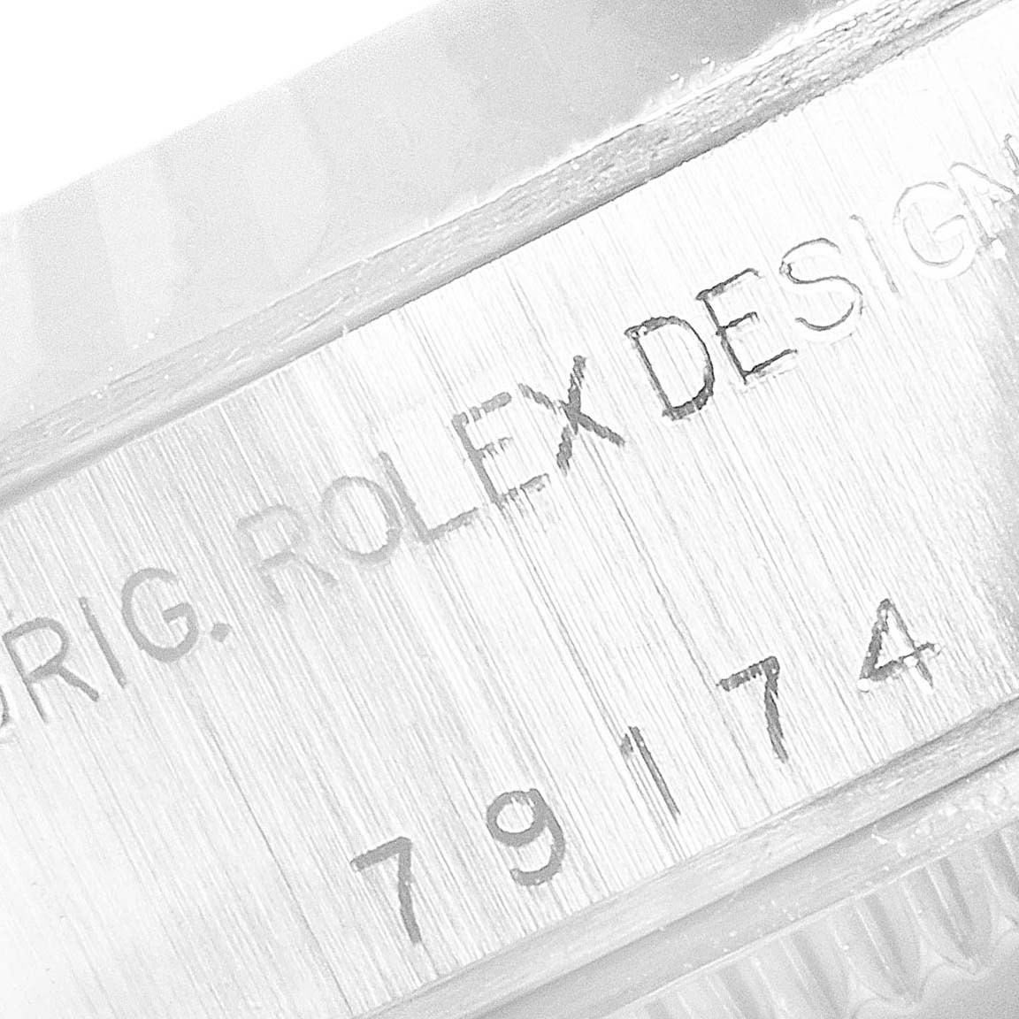 The image shows a close-up angle of the case side of a Rolex Datejust 79174 Women
s Stainless Steel White Dial 79174 Women
s Stainless Steel White Dial watch, displaying the engravings.