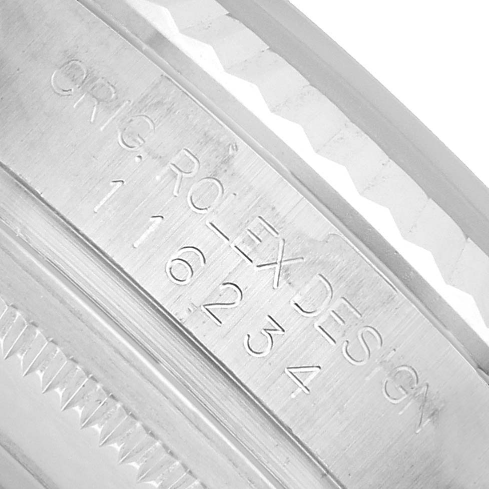 The image shows the engraved case side of a Rolex Datejust 116234 Men's Stainless Steel Silver Dial, highlighting its model number and design details.