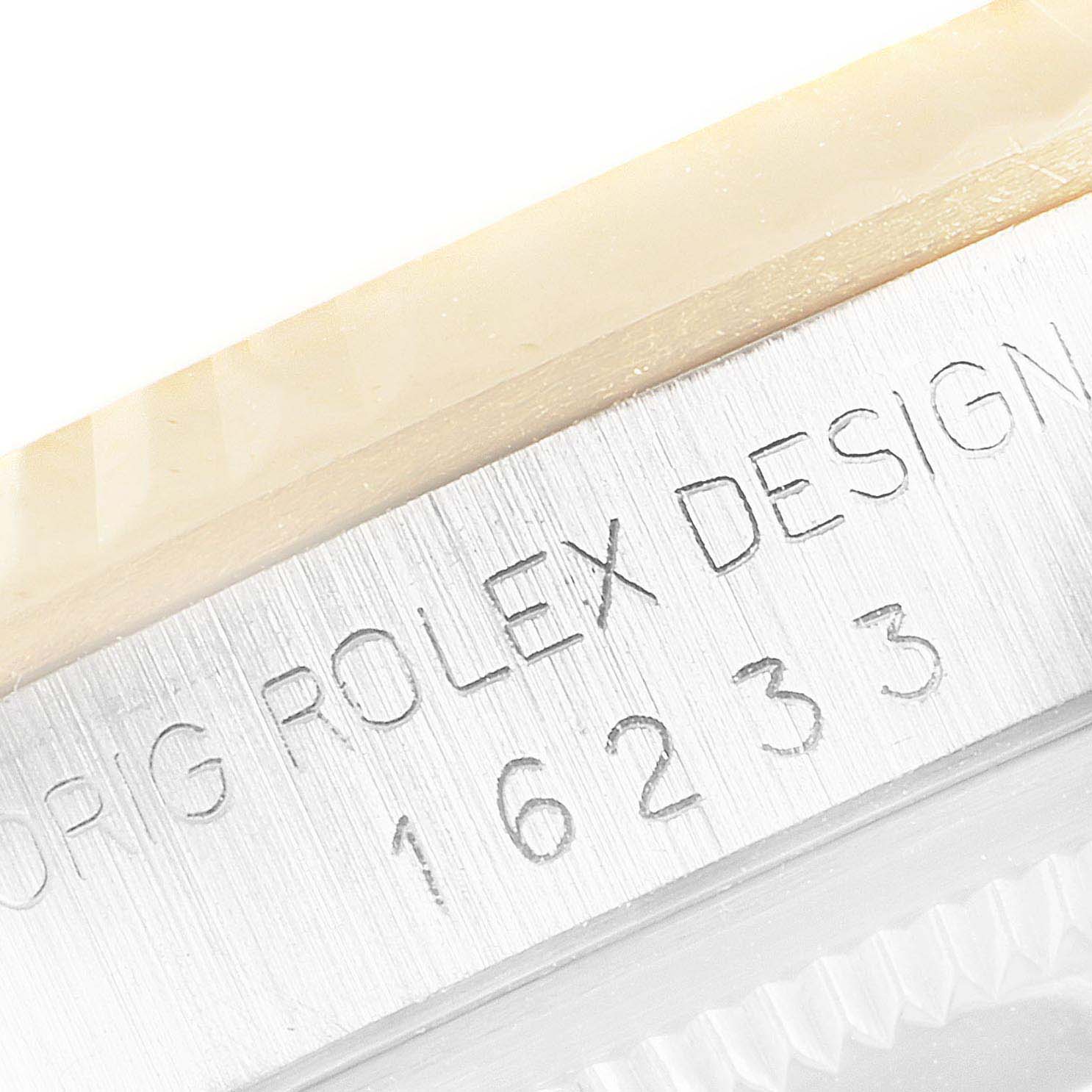 This close-up image shows the engraved model number "16233" and "ORIG ROLEX DESIGN" on the side of a Rolex Datejust 16233 Men's Steel and Gold (two tone) Black Dial 16233 Men's Steel and Gold (two tone) Black Dial watch.