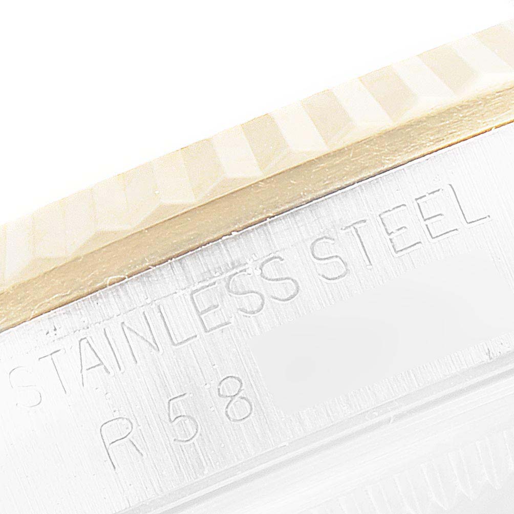 This image shows a close-up of the engraved serial number and stainless steel case of the Rolex Datejust 16233 Men's Steel and Gold (two tone) Black Dial 16233 Men's Steel and Gold (two tone) Black Dial watch.