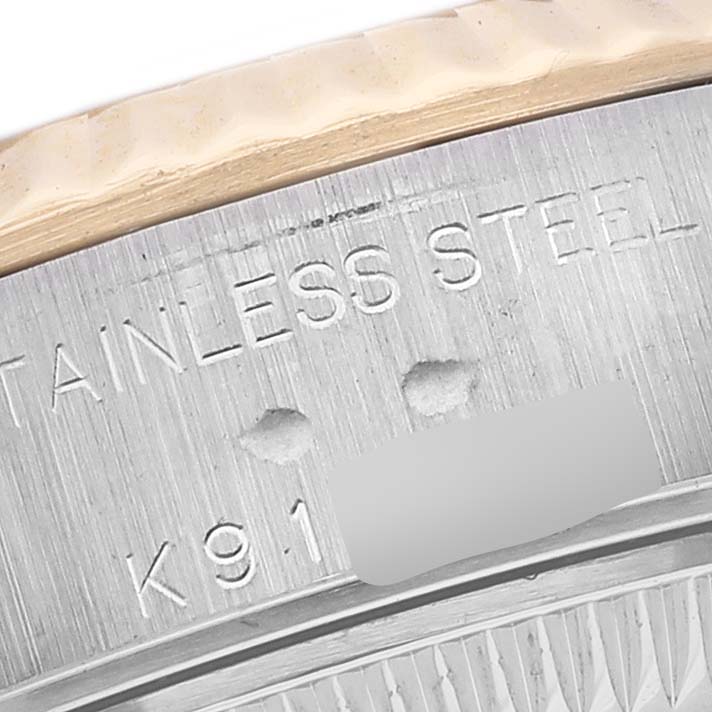 This image shows a close-up of the stainless steel case back edge inscription on a Rolex Datejust 79173 Women's Steel and Gold (two tone) Black Dial 79173 Women's Steel and Gold (two tone) Black Dial watch.