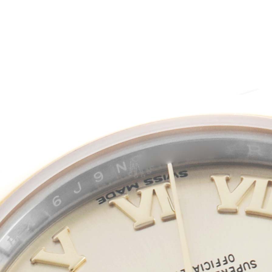The image shows a close-up of the dial's edge of a Rolex Datejust 279163 Women's Steel and Gold (two tone) Champagne Dial, featuring Roman numerals and part of the hands.