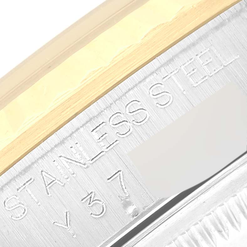 This close-up image shows an engraved stainless steel part of a Rolex Datejust 16233 Men's Steel and Gold (two tone) White Dial 16233 Men's Steel and Gold (two tone) White Dial watch.