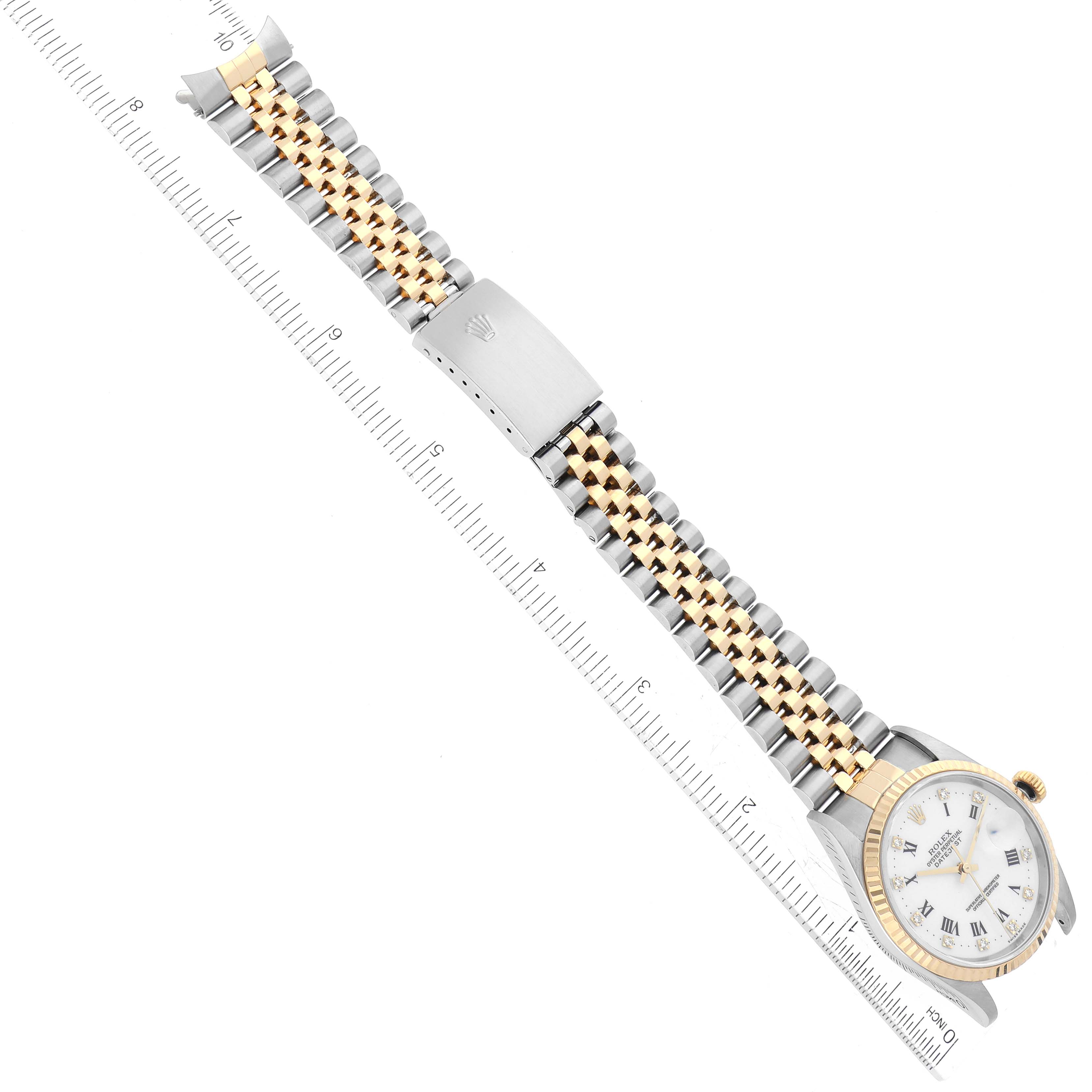 The image displays the Rolex Datejust 16233 Men's Steel and Gold (two tone) White Dial 16233 Men's Steel and Gold (two tone) White Dial watch from an overhead angle, showing the dial, bezel, and two-tone bracelet with a ruler for scale.