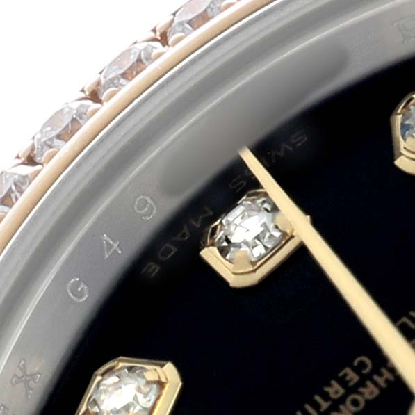 The image shows a close-up of the Rolex Datejust 179383 Women's Steel and Gold (two tone) Black Dial bezel, diamonds, and part of the dial with a single hand.