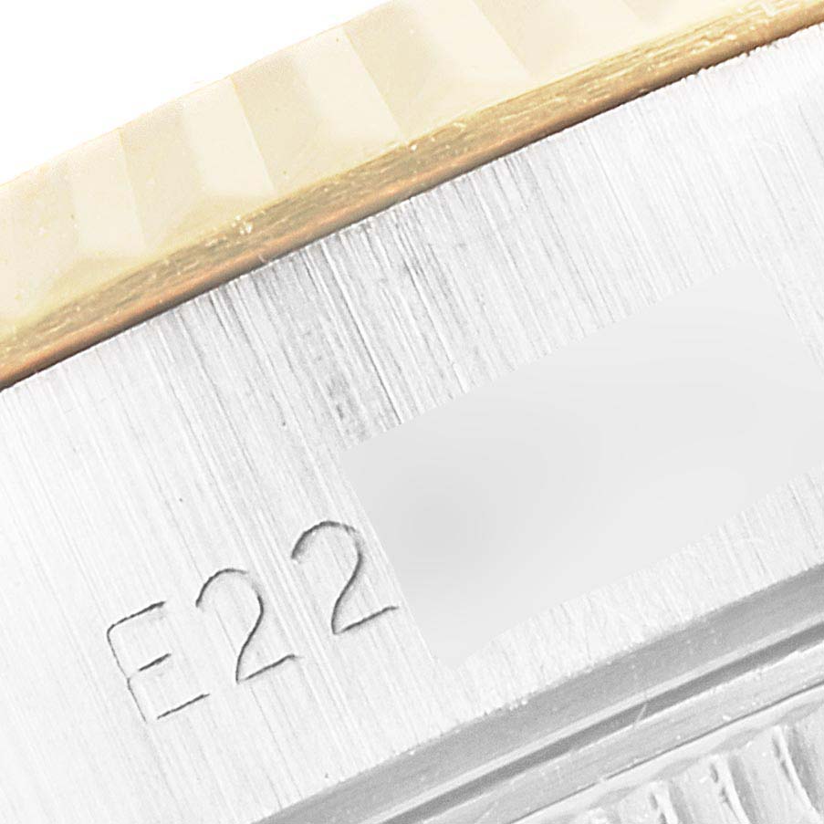 This close-up angle shows the engraved edge of a Rolex Datejust 69173 Women's Steel and Gold (two tone) Champagne Dial 69173 Women's Steel and Gold (two tone) Champagne Dial watch, highlighting part of the bezel and casing.