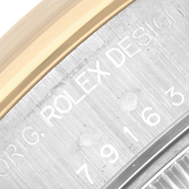 The image shows a close-up of the bezel and case side, with engraved details of a Rolex Datejust 79163 Women's Steel and Gold (two tone) Mother of Pearl Dial 79163 Women's Steel and Gold (two tone) Mother of Pearl Dial watch.
