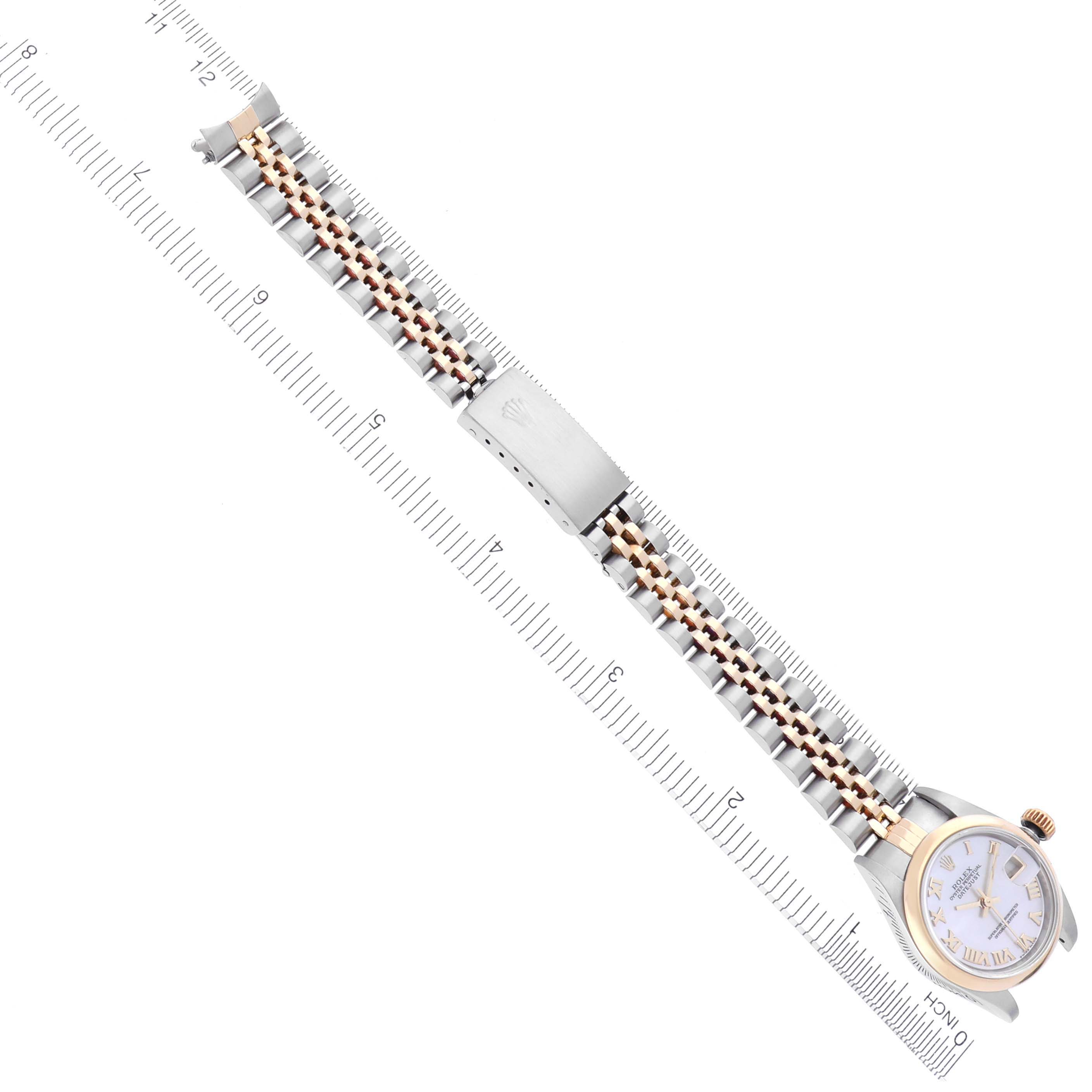 The image shows a Rolex Datejust 79163 Women's Steel and Gold (two tone) Mother of Pearl Dial 79163 Women's Steel and Gold (two tone) Mother of Pearl Dial watch laid flat, highlighting the face, case, bracelet, and clasp against a ruler backdrop.